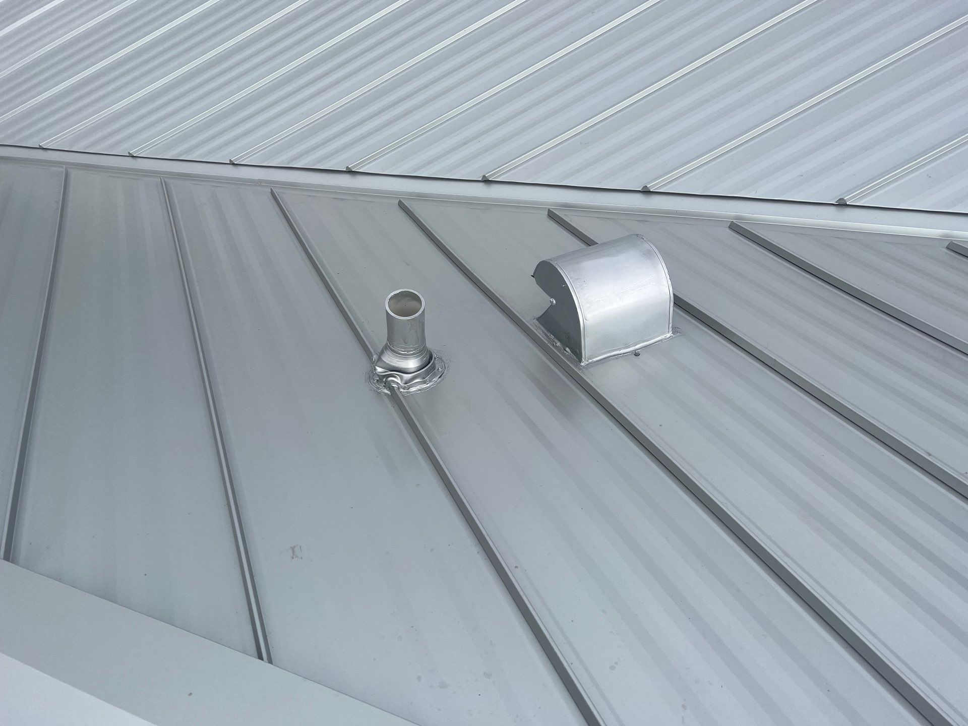 Residential Roofing Installation using Galvalume Standing Seam by Durabilis Roofing INC