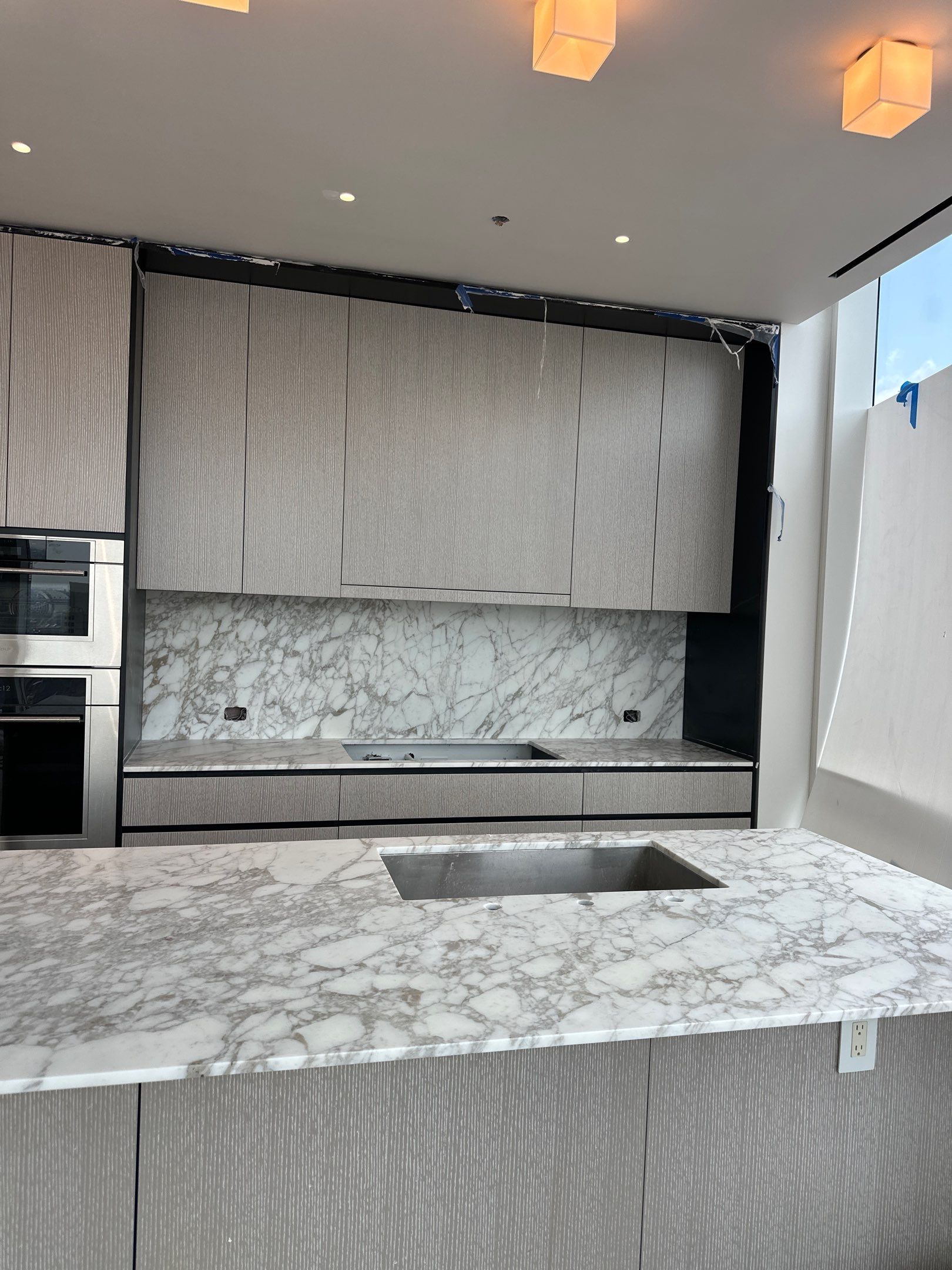 Kitchen Countertop with backsplash and Island top with mitered waterfalls by NC Stone And Tiles