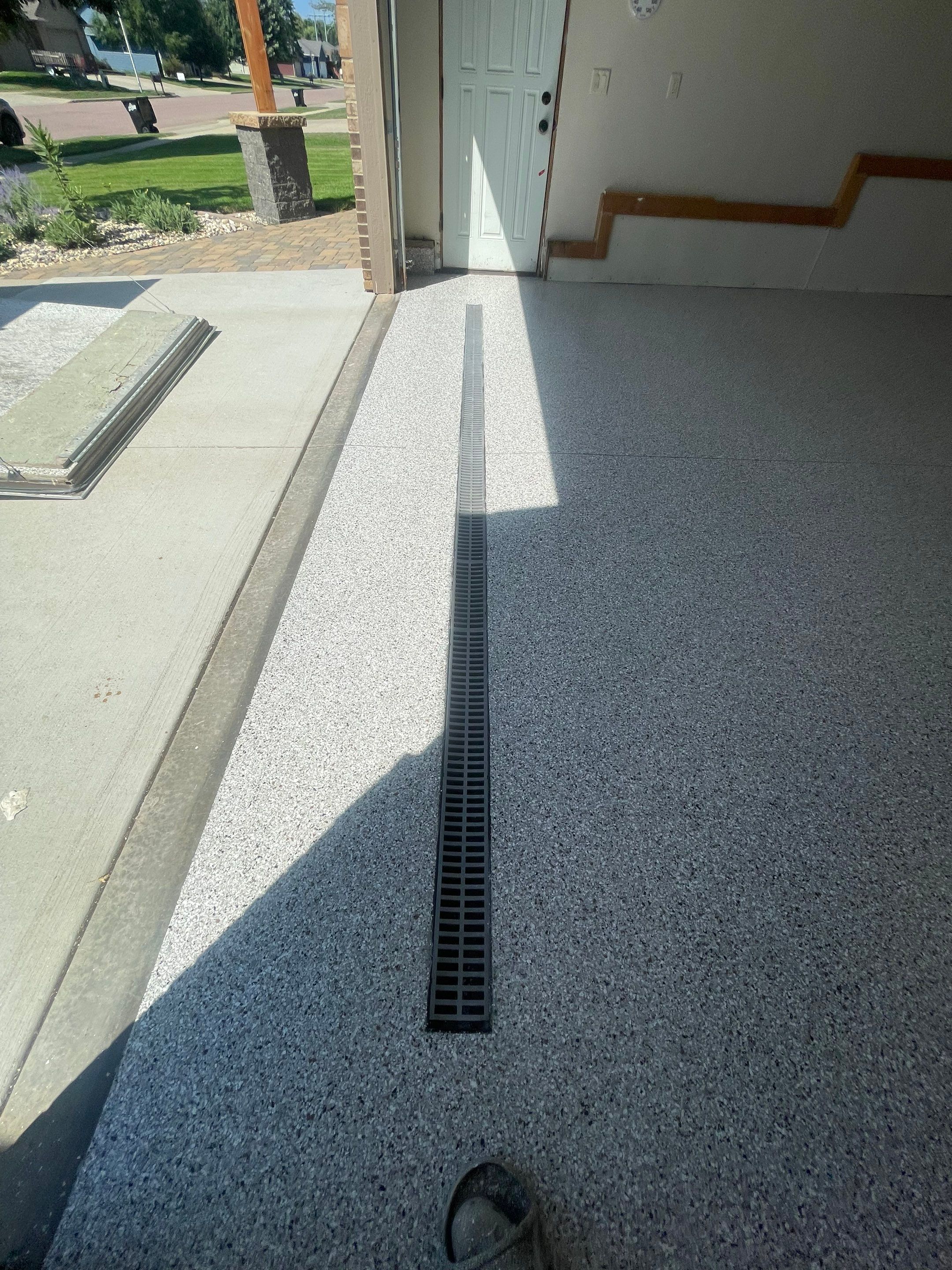 Multi-Stall Garage Floor Coating Installation in Sioux Falls by Select Painting, Coatings & Garage Cabinets