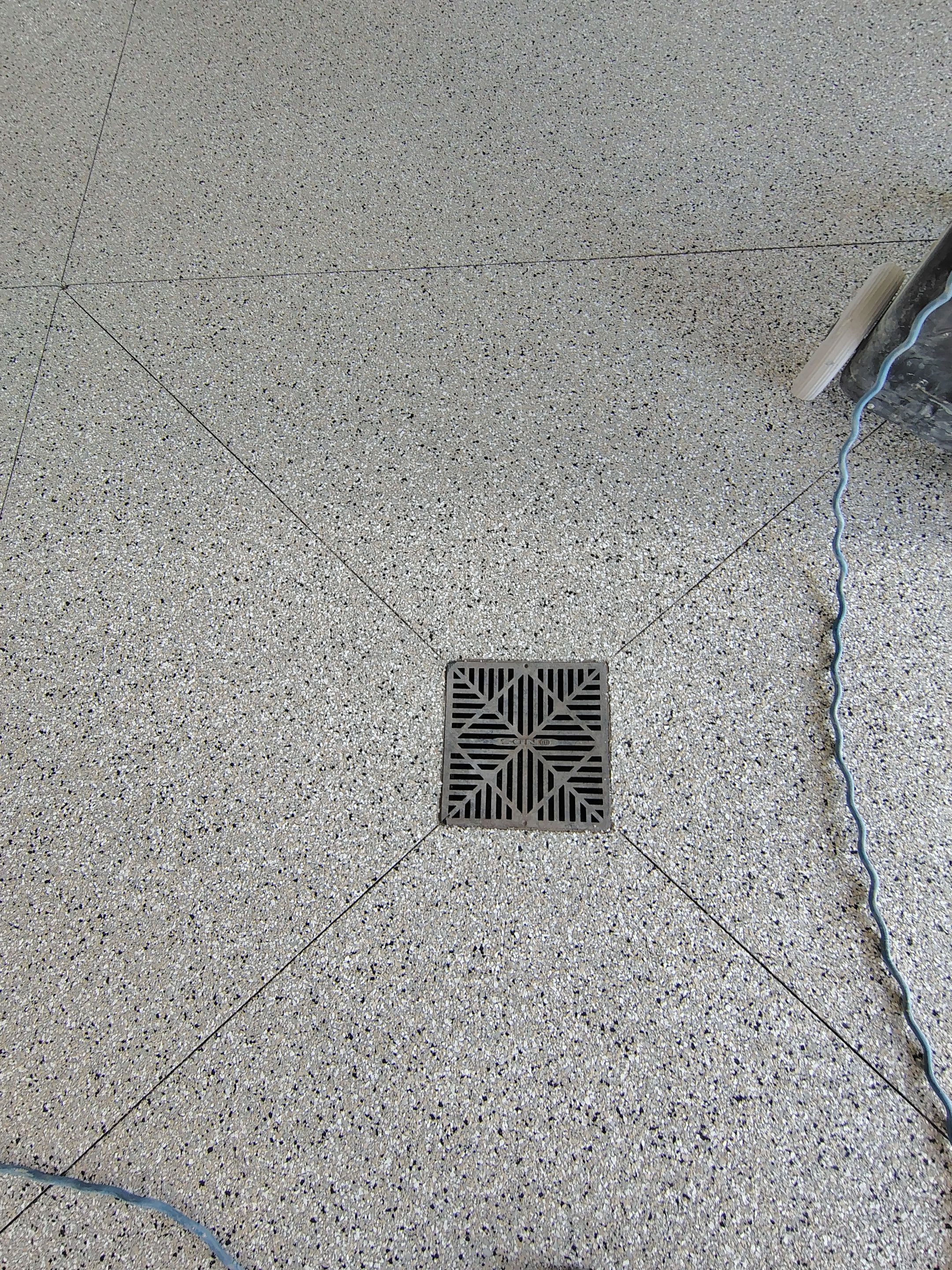Speckled Polyaspartic Garage Floor Coating Installation in Dell Rapids by Select Painting, Coatings & Garage Cabinets
