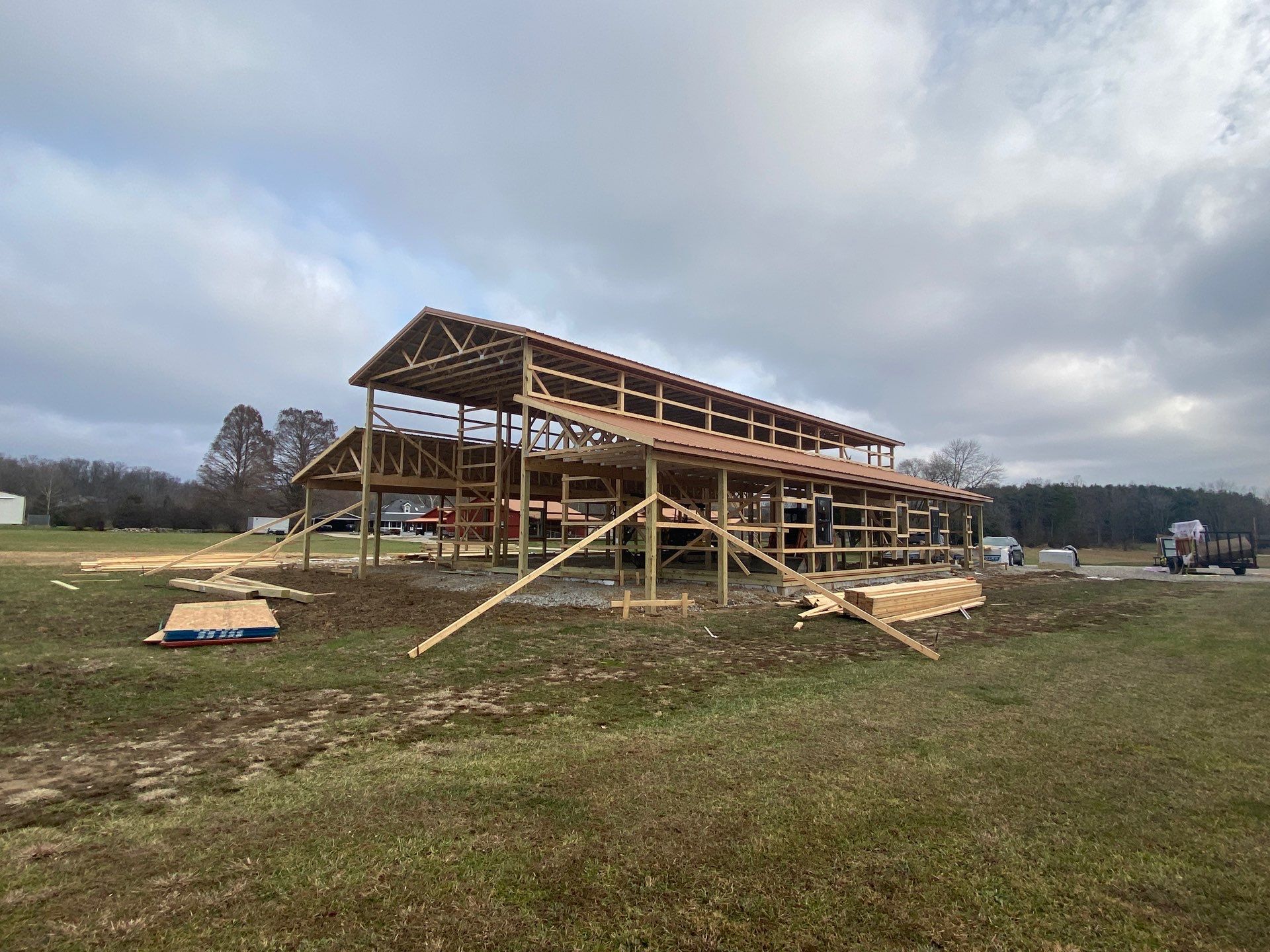 Custom Pole Barn Home with Charcoal Siding and Copper Roof by The Barn Builders