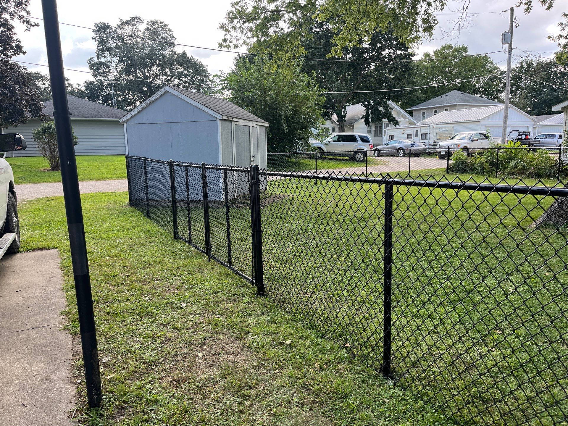 Black Chain Link Perimeter Fence and Gate Installation in Shell Rock by Perfect Picket Fence and Stain