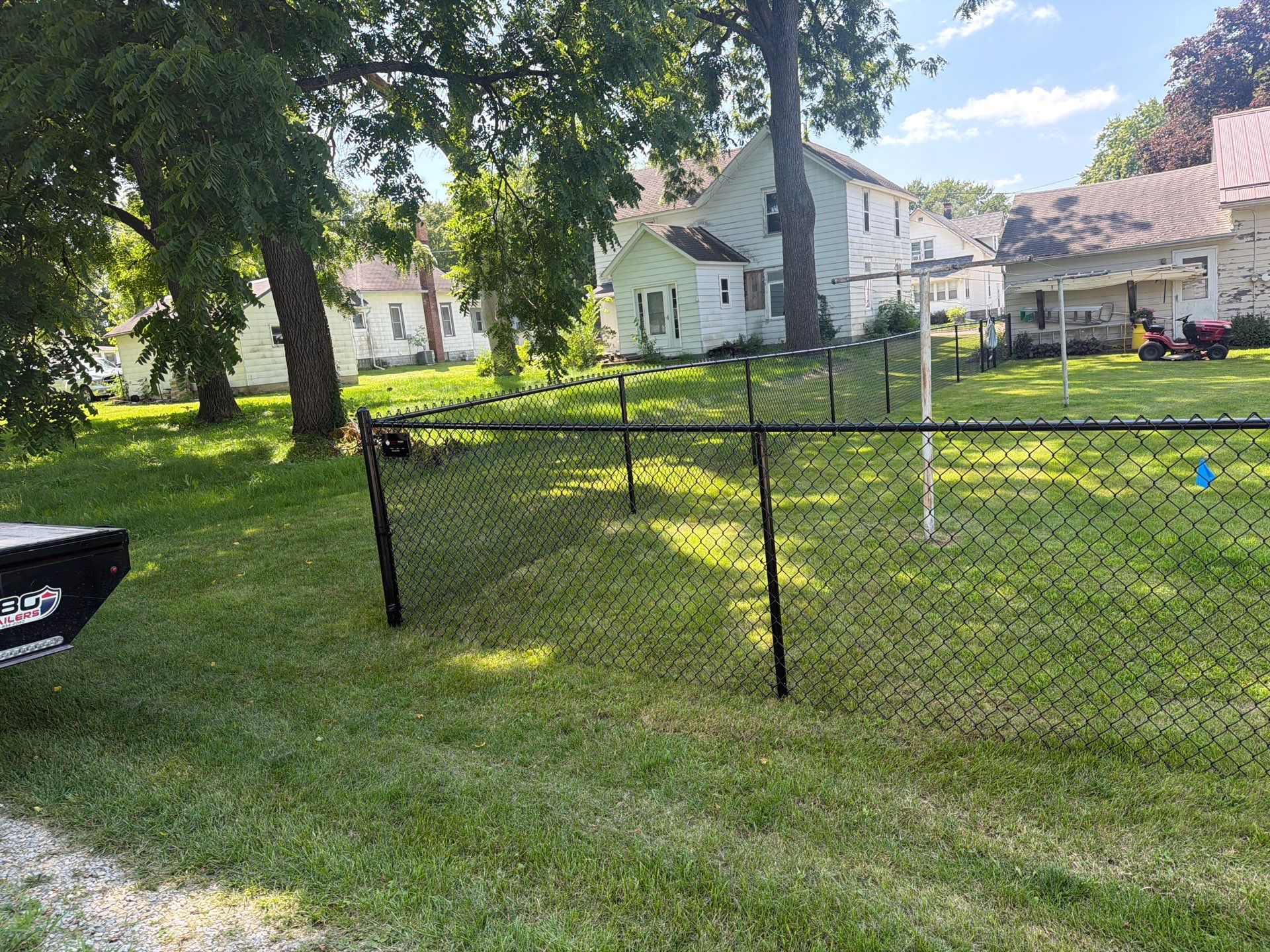 Black Chain Link Backyard Fence Installation in Tripoli, IA by Perfect Picket Fence and Stain