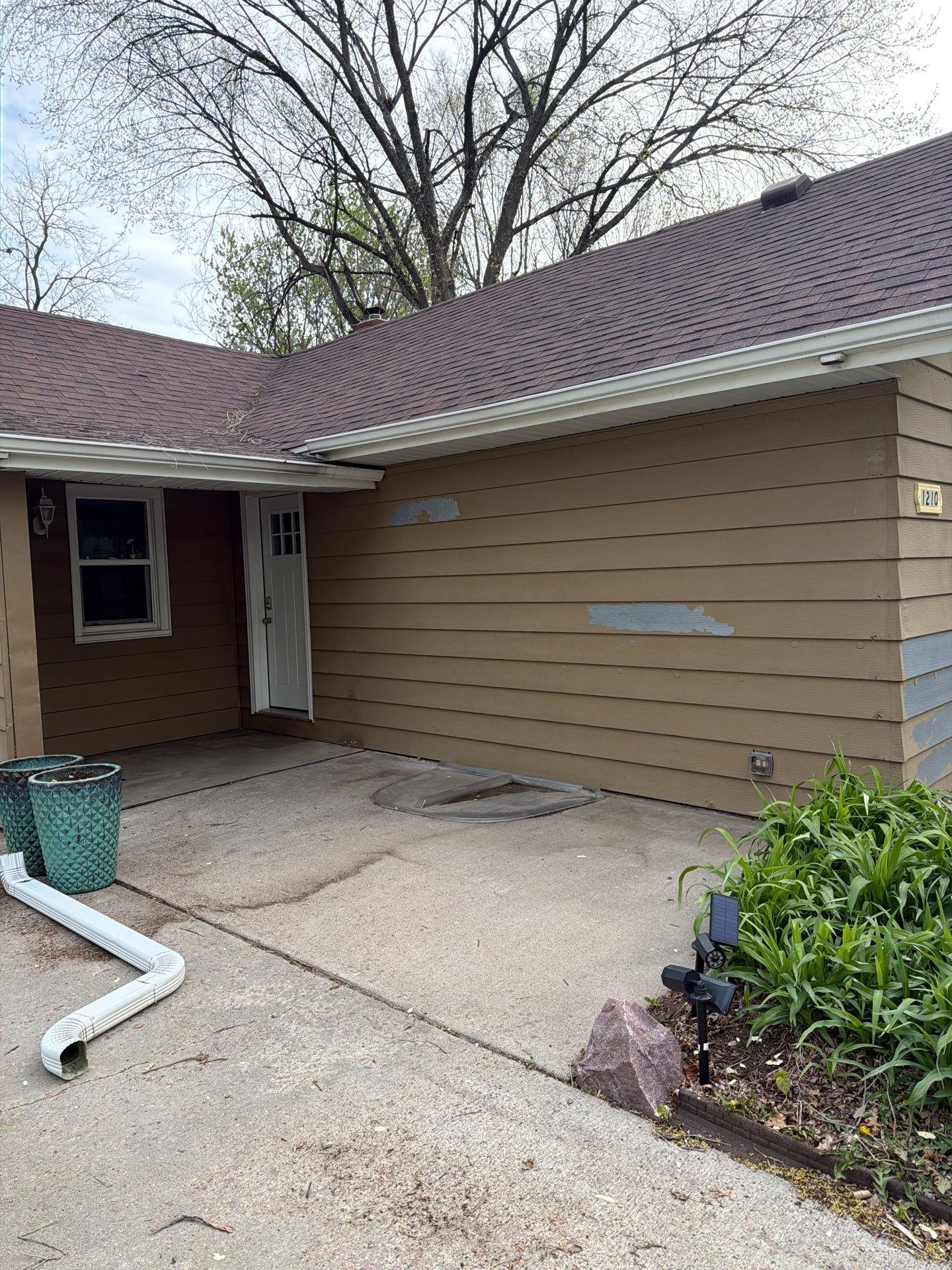 Exterior Siding Repair and Full House Repaint in Sioux Falls by Select Painting, Coatings & Garage Cabinets