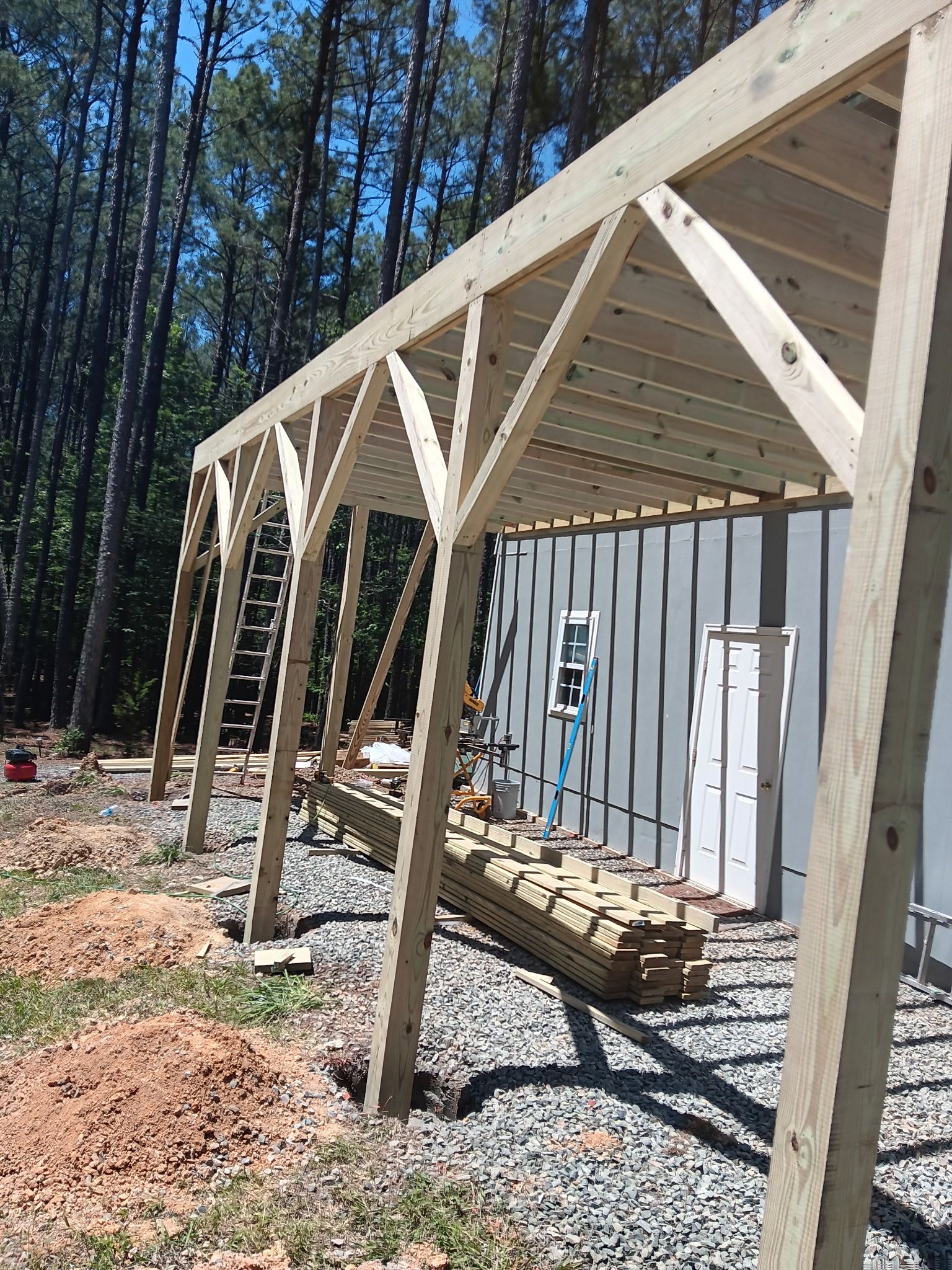 Pittsboro Outdoor Living Transformation – Retaining Wall, Paver Patio & Elevated Deck by Elite Remodeling and Design LLC