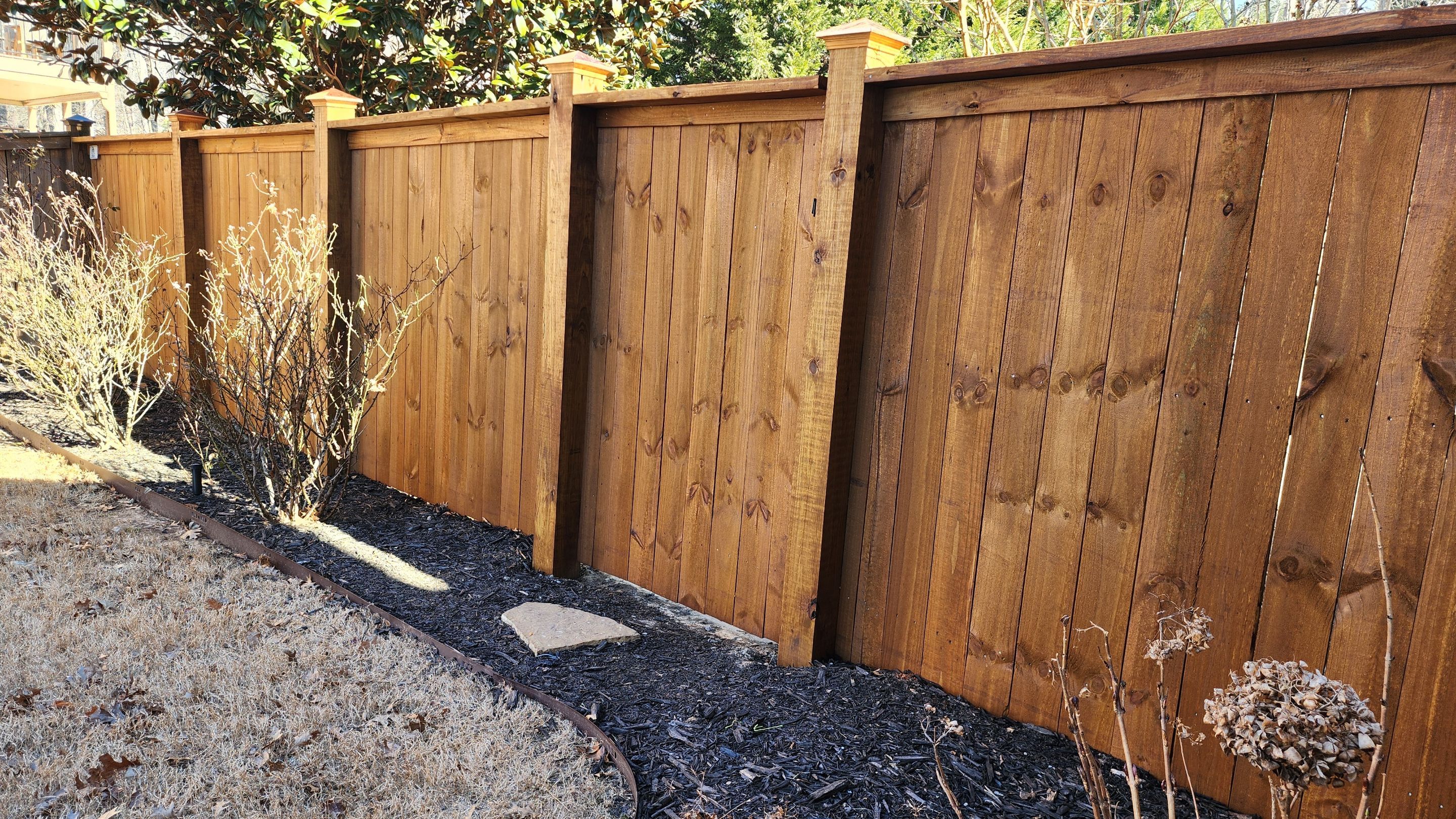 Fence Installation of Capped Wood Privacy Fence using 6X6 posts and copper post caps.  by Titans of Timber Fence & Stain
