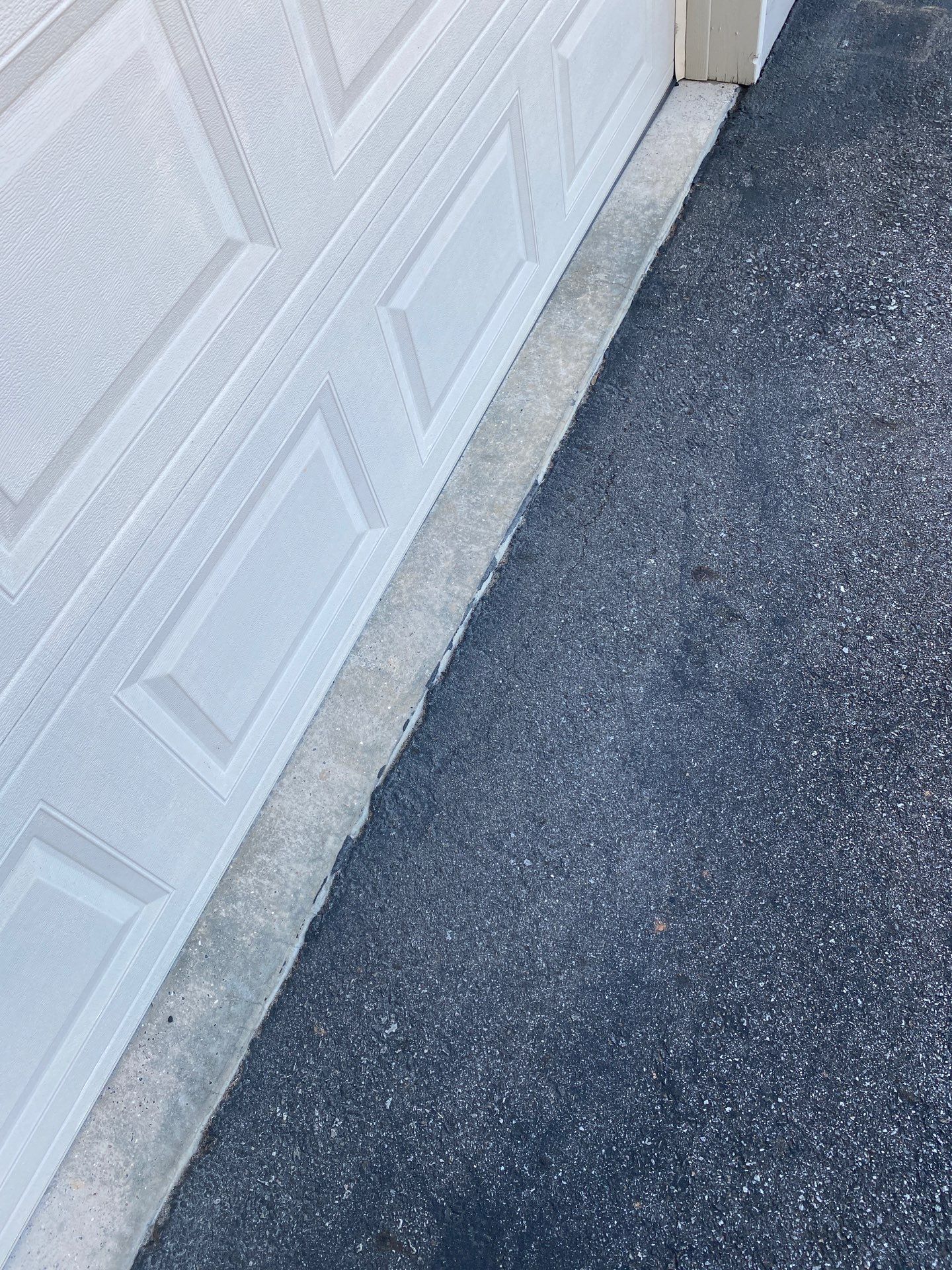 cleaning of driveway and garage door surfaces using pressure washing techniques to remove dirt and grime