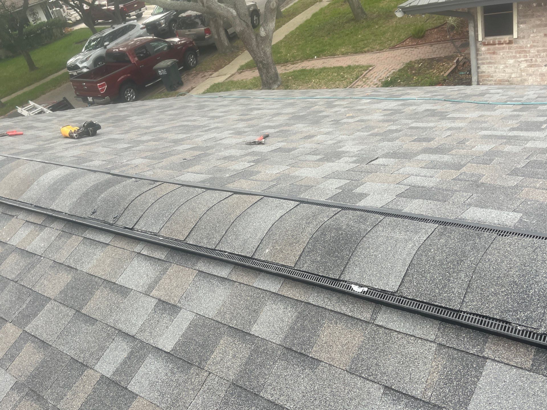 Colored Vinyl Windows to blend into brick by Bayfront Roofing and Construction