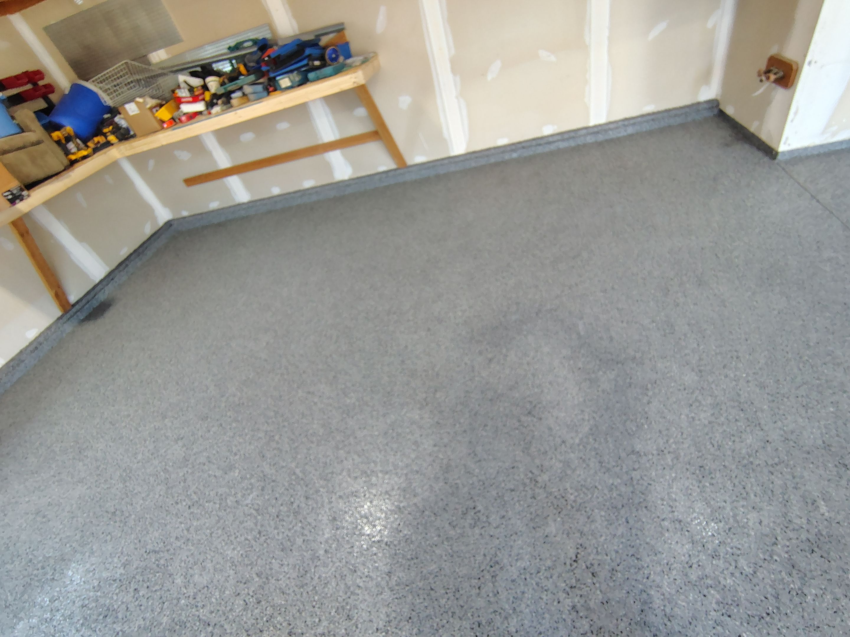 Sioux Falls Garage Concrete Grinding and Nightfall Decorative Chip Coating by Select Painting, Coatings & Garage Cabinets