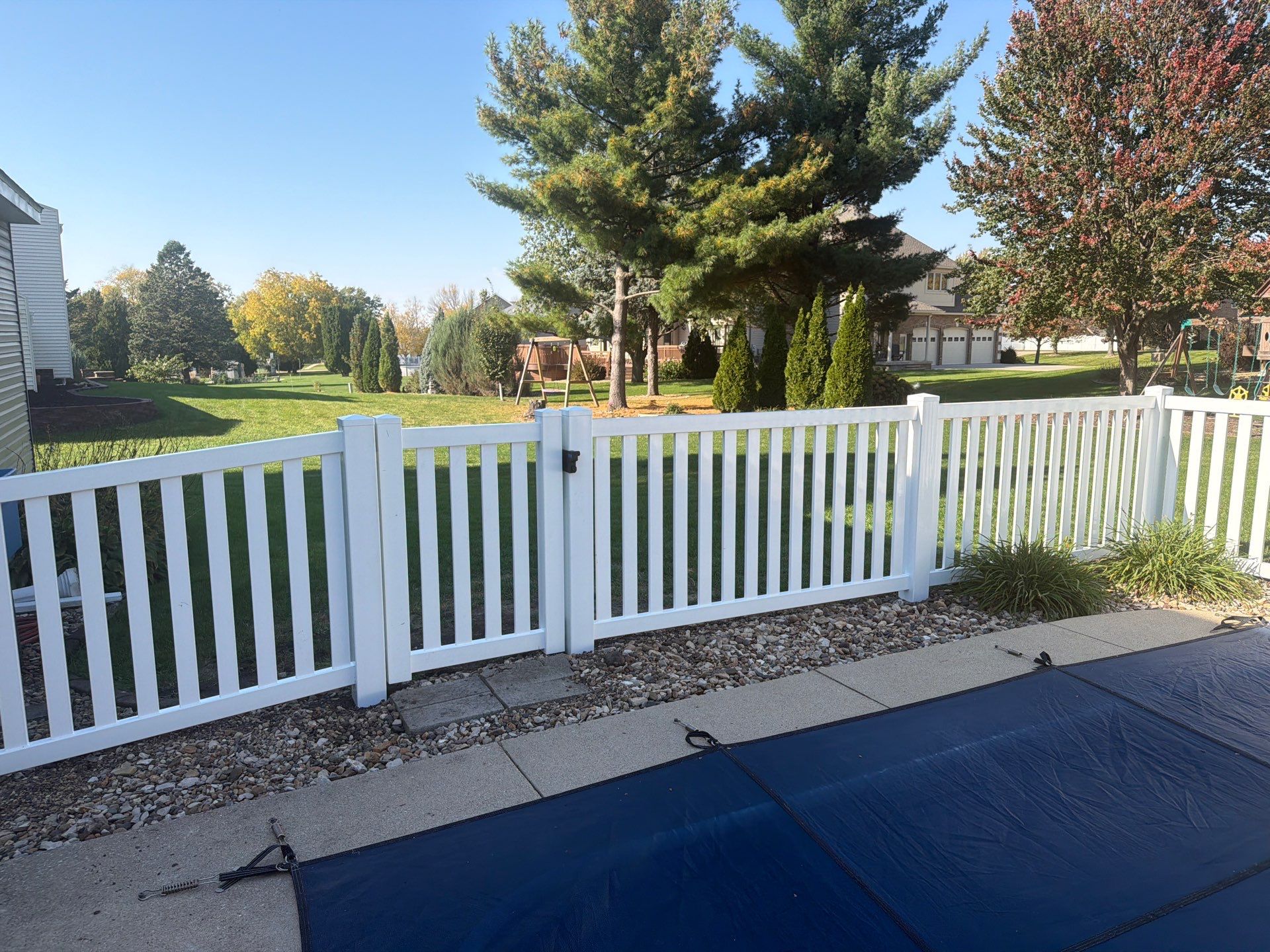 White Vinyl Picket Pool Fence Installation in Waterloo, Iowa by Perfect Picket Fence and Stain