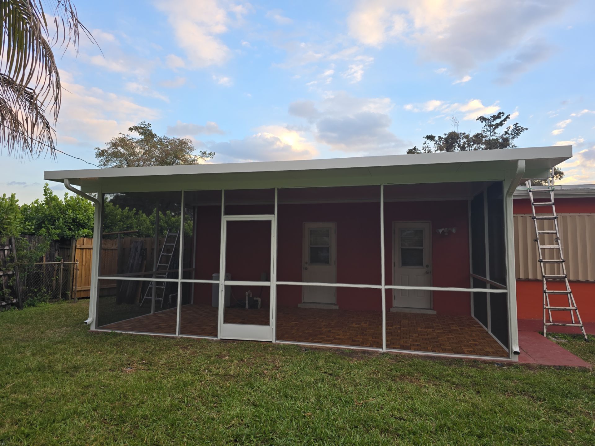 Insulated Screen Enclosure and Wood Tile Deck Installation in Plantation by Aastro Roofing