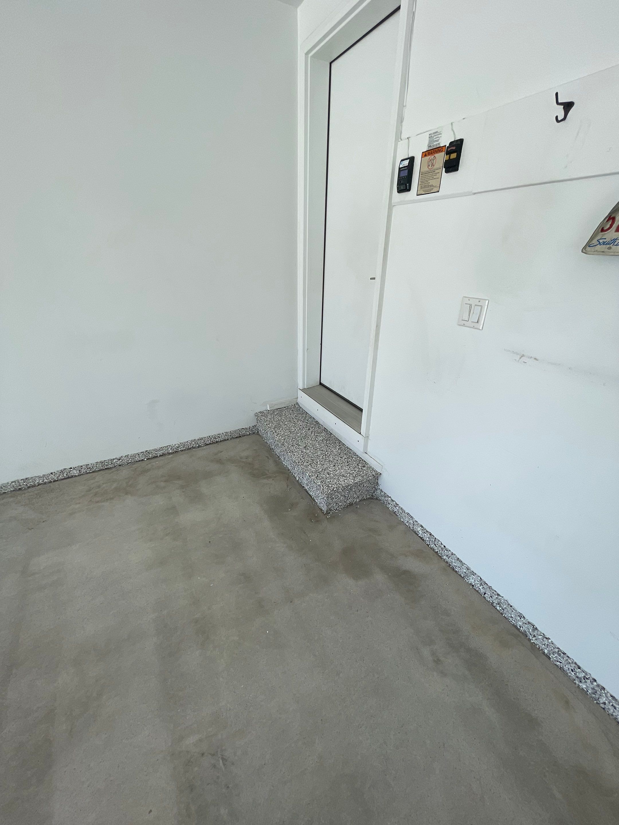 Yankton Garage Floor Restoration with Gray Speckled Epoxy Coating by Select Painting, Coatings & Garage Cabinets