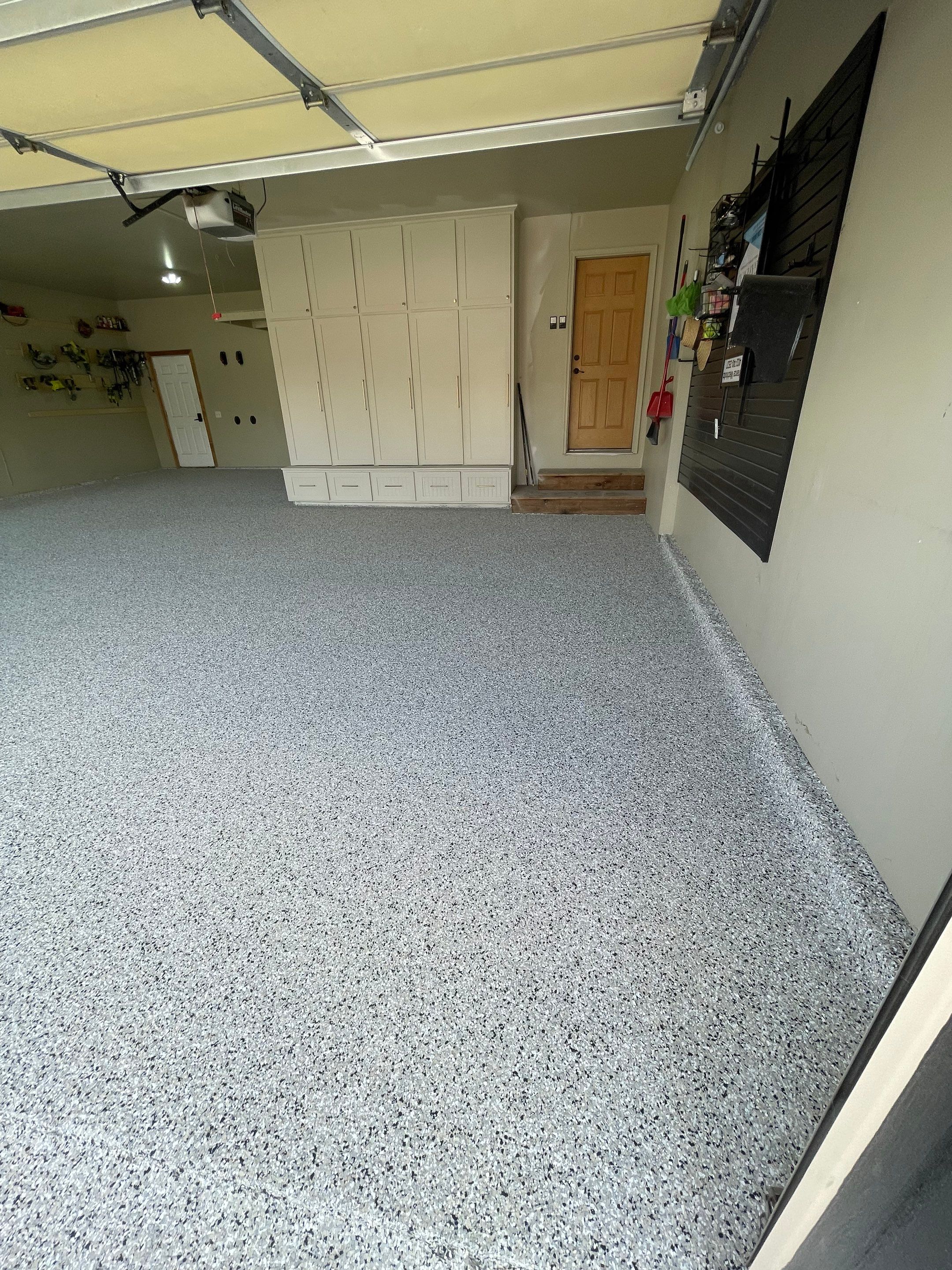 Cabin FEver Flake Garage Floor Coating Installation in Sioux Falls by Select Painting, Coatings & Garage Cabinets
