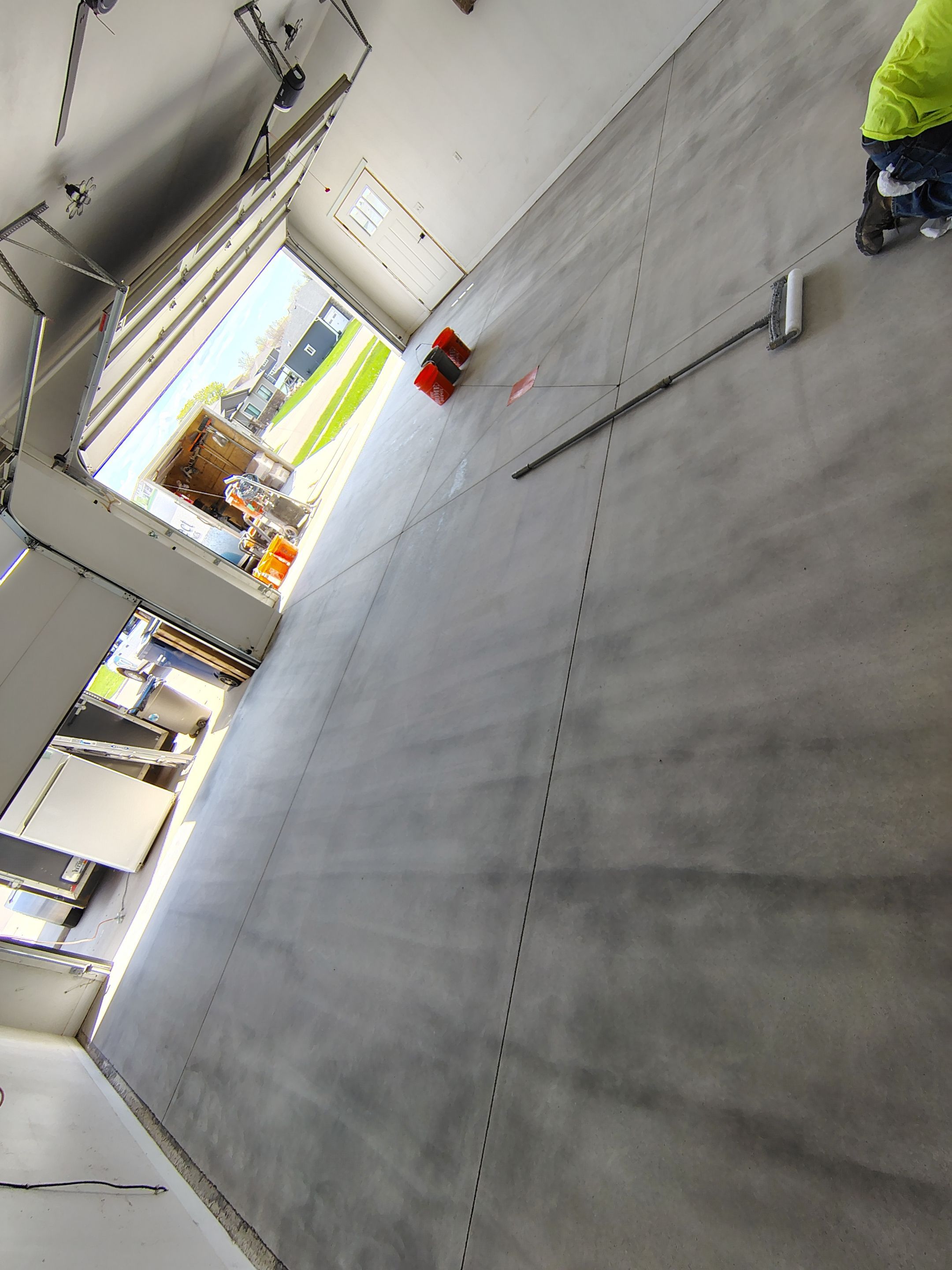 Speckled Polyaspartic Garage Floor Coating Installation in Dell Rapids by Select Painting, Coatings & Garage Cabinets