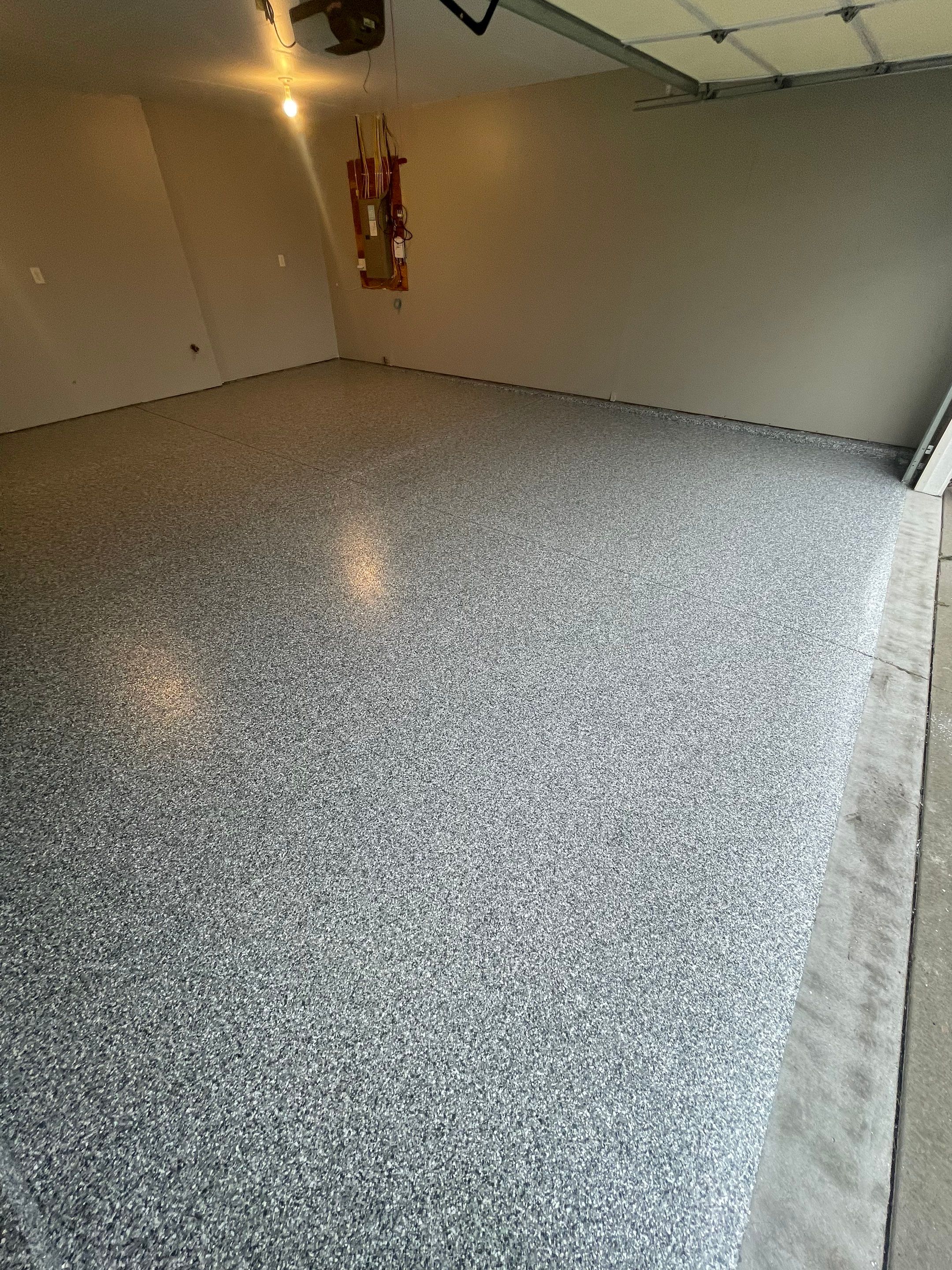 Custom Polyurea Flake Garage Floor Installation in Sioux Falls by Select Painting, Coatings & Garage Cabinets