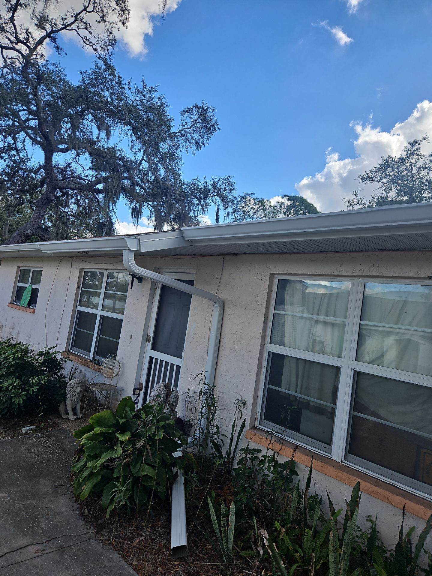 Downspout Installation using White Down Spouts in Sarasota FL by Gutter Professors