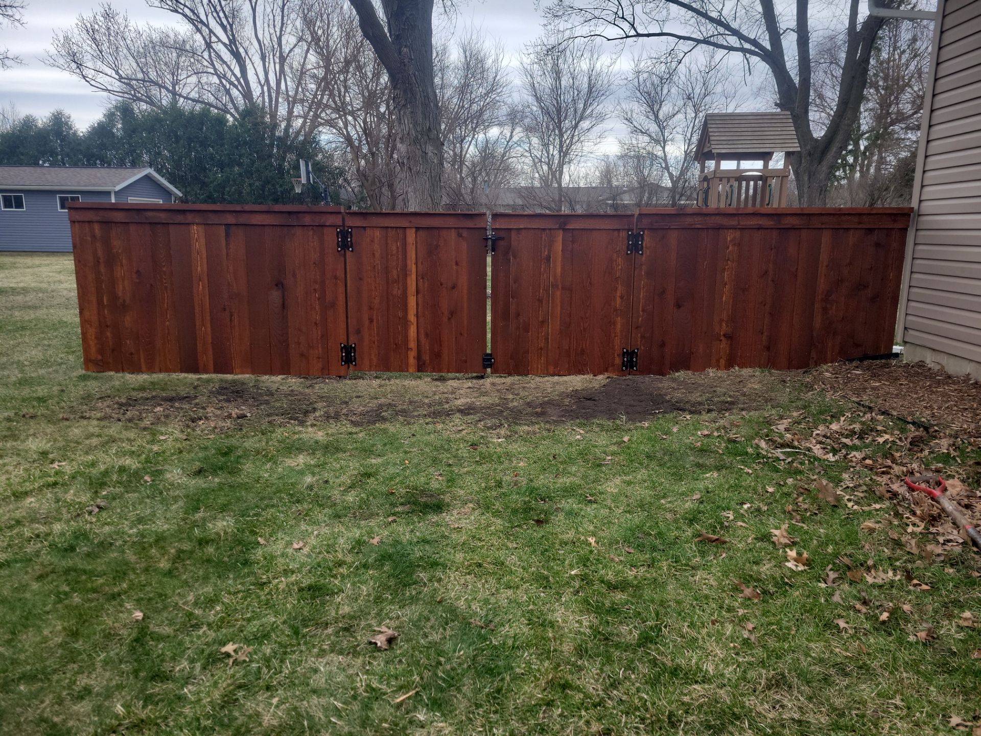 Dark Stained Cedar Privacy Fence and Custom Gates in Cedar Falls by Perfect Picket Fence and Stain