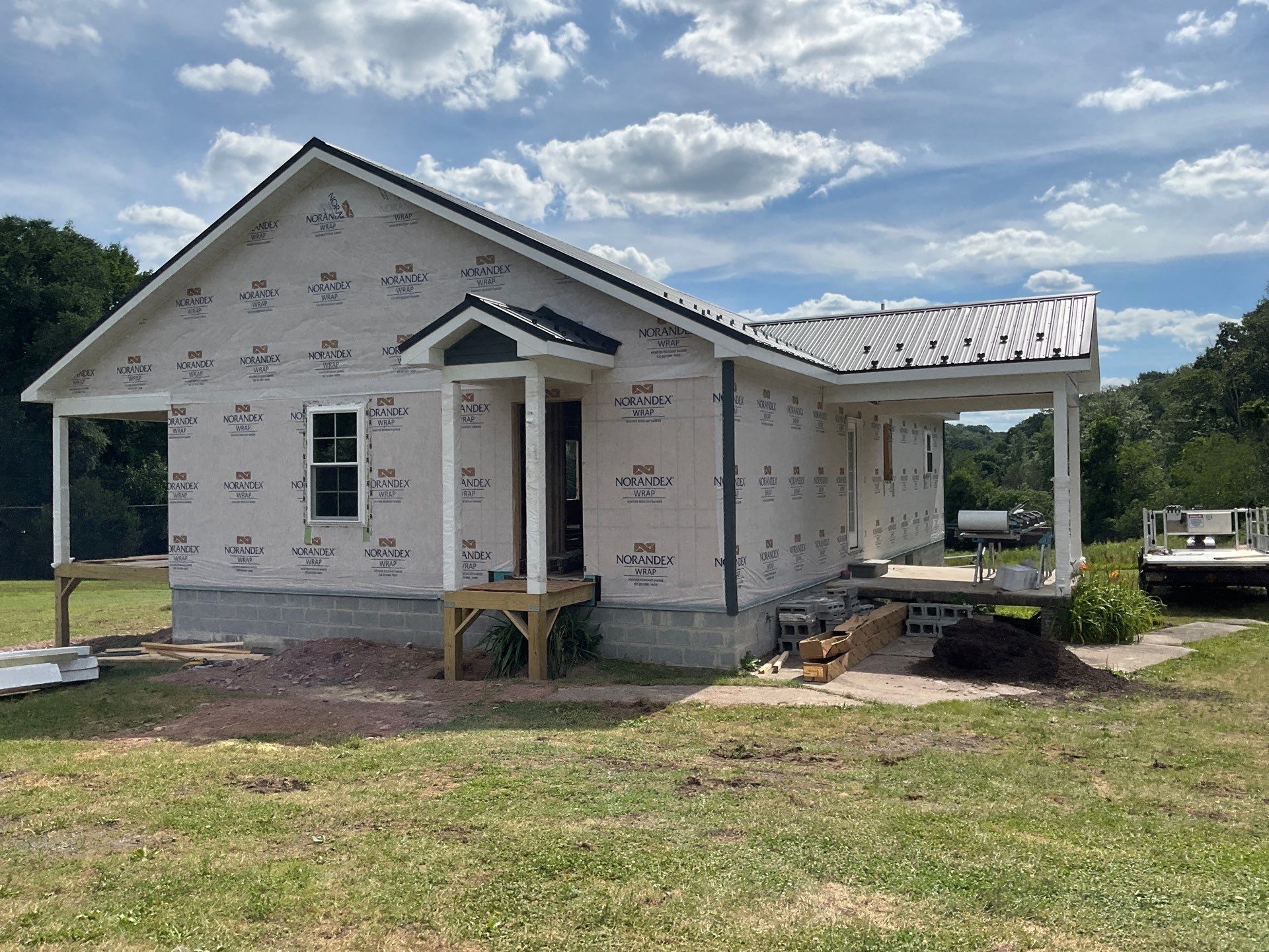 New Residential Addition with Blue Siding and Metal Roofing in Ashland by Esh Builders