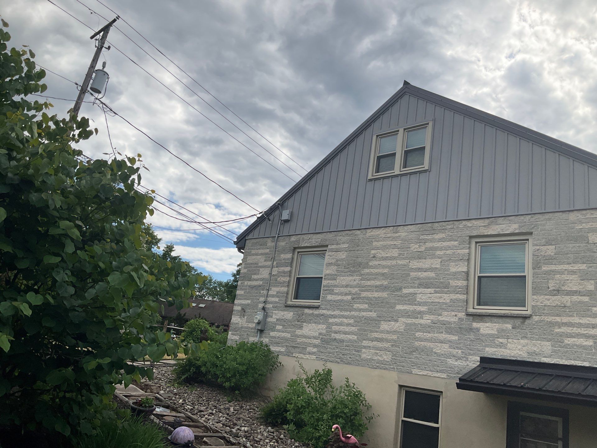 Metal Roofing, Board & Batten Siding, and Entry Door Transformation by Esh Builders