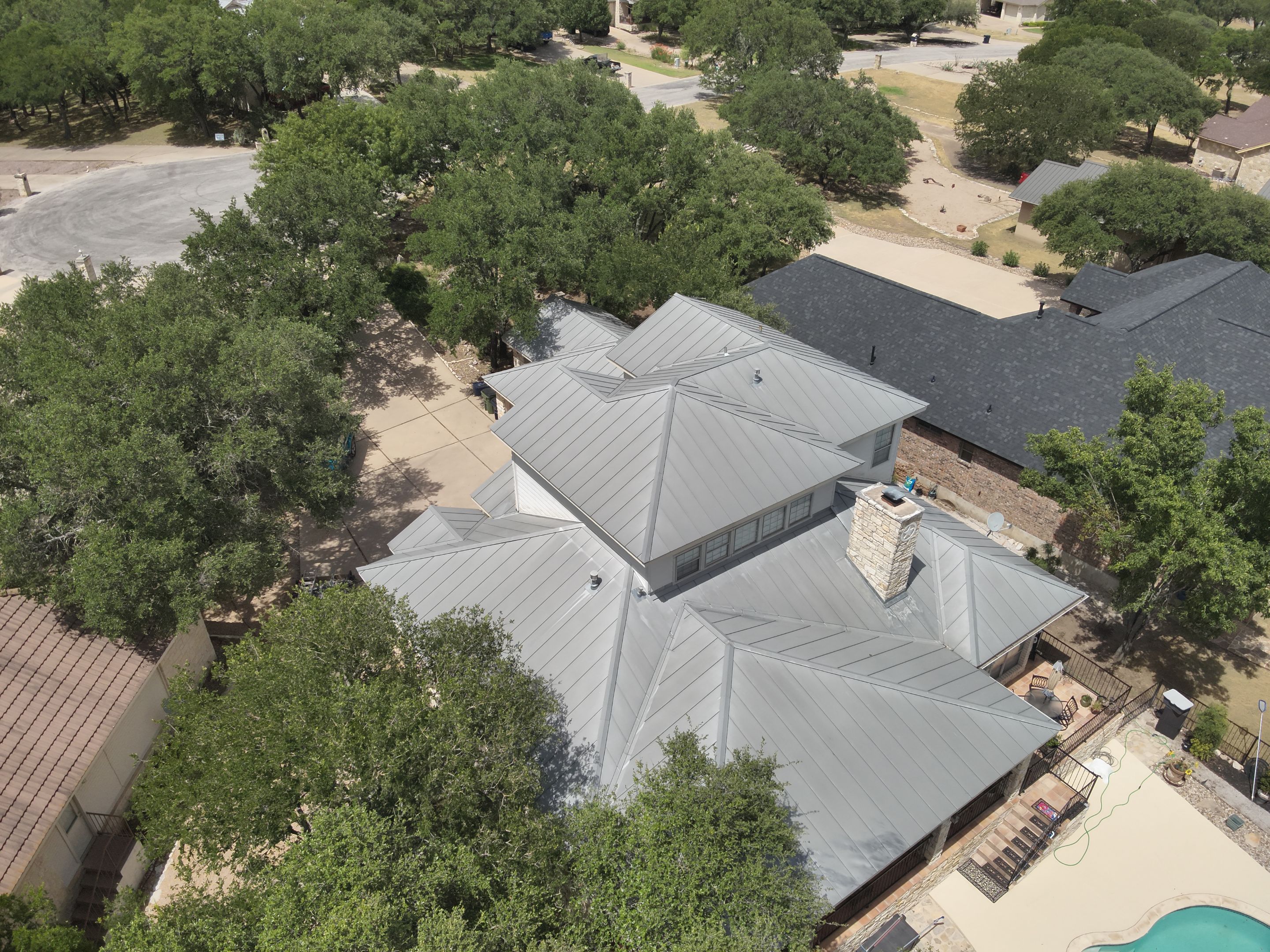 Residential Roof Replacement using 24 GA Double-Lock - Surrey Beige by Action Exteriors Austin