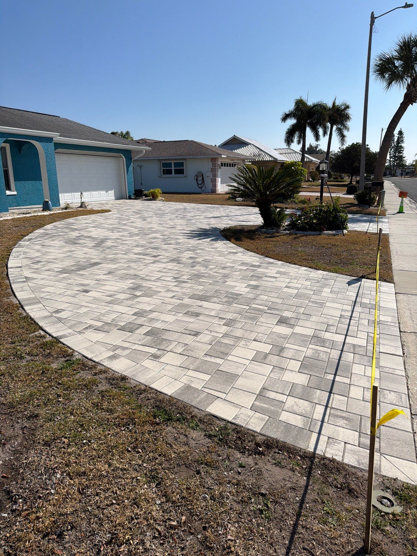 Modern Gray Paver Driveway and Entryway Walkway in Sun City Center by Supreme Paver Experts