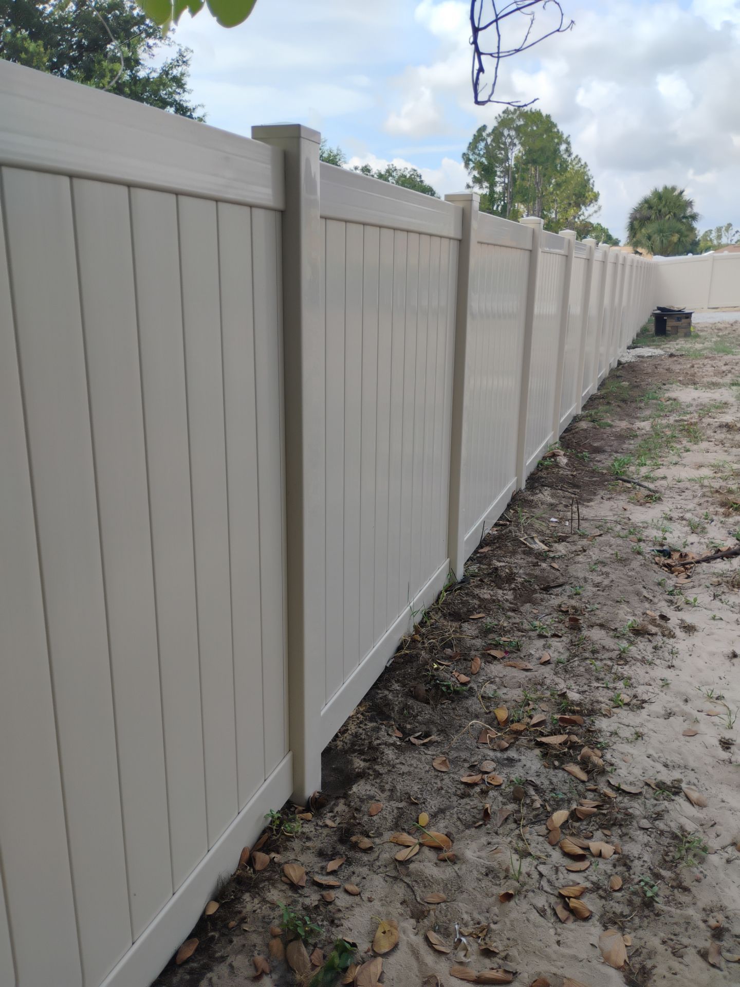 Tan Vinyl Privacy Fence and Gate Installation in North Port by True Fence LLC
