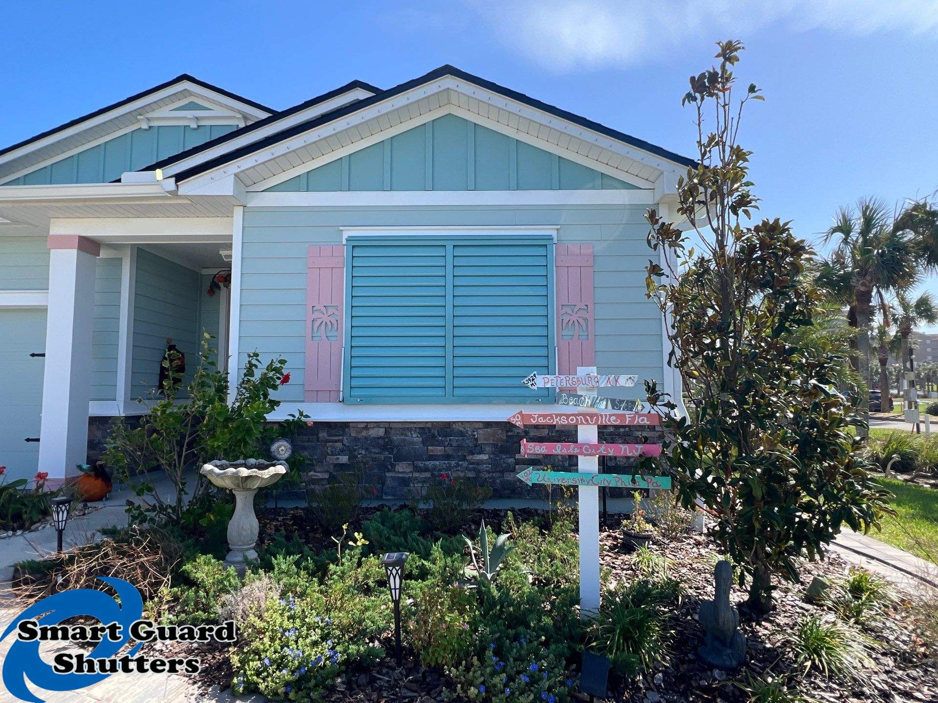 Impact Bahama Shutters in Pastel Turquoise by Smart Guard Shutters