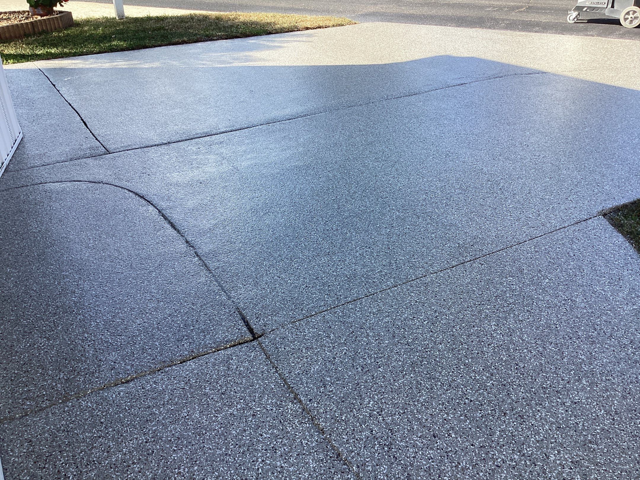 Driveway using Pebble Beach by Amvet concrete coatings llc