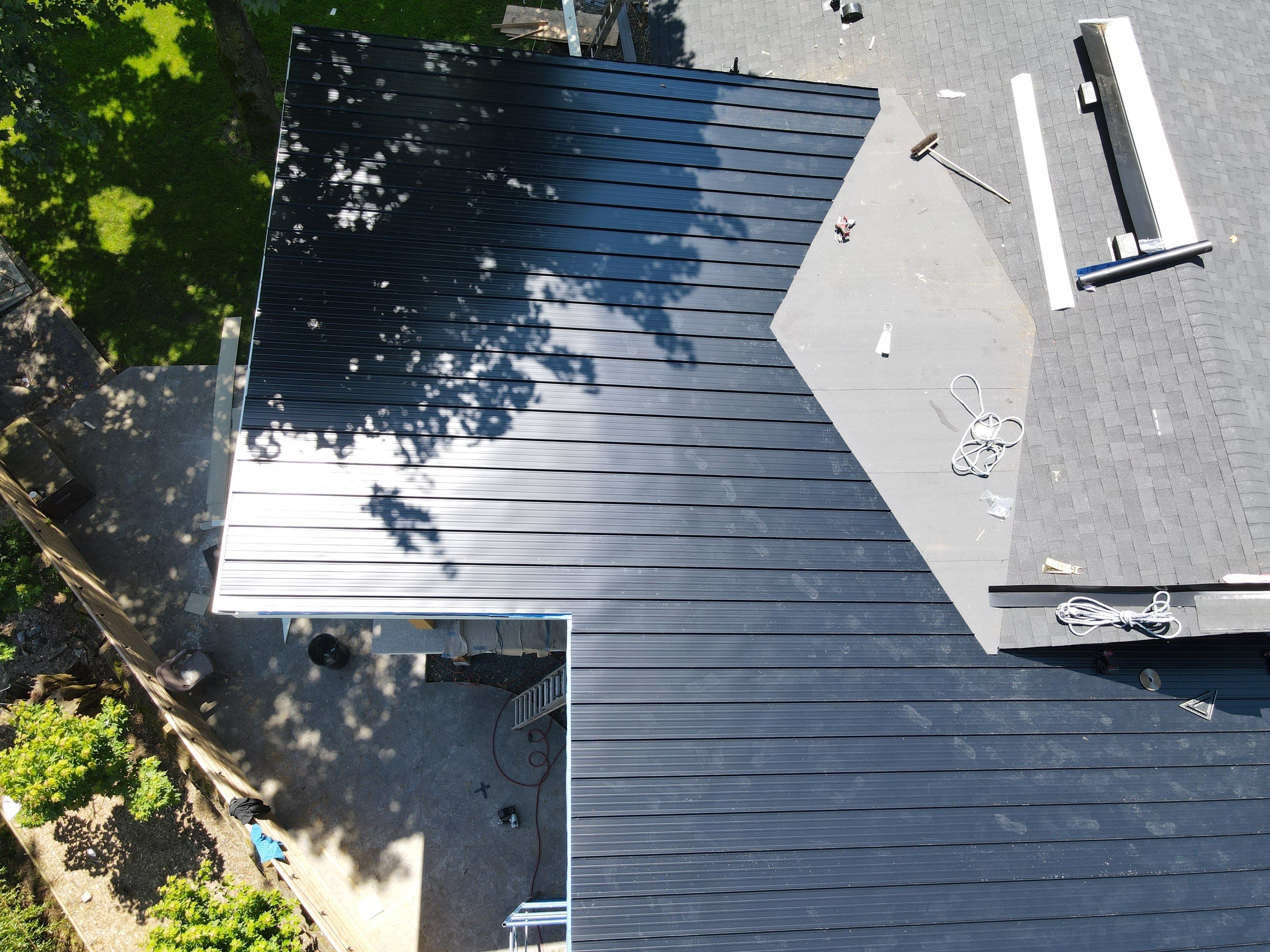Residential Roofing Installation using 12" Prolok metal, shingles and Torch on roofing by Top Notch Roofing Inc