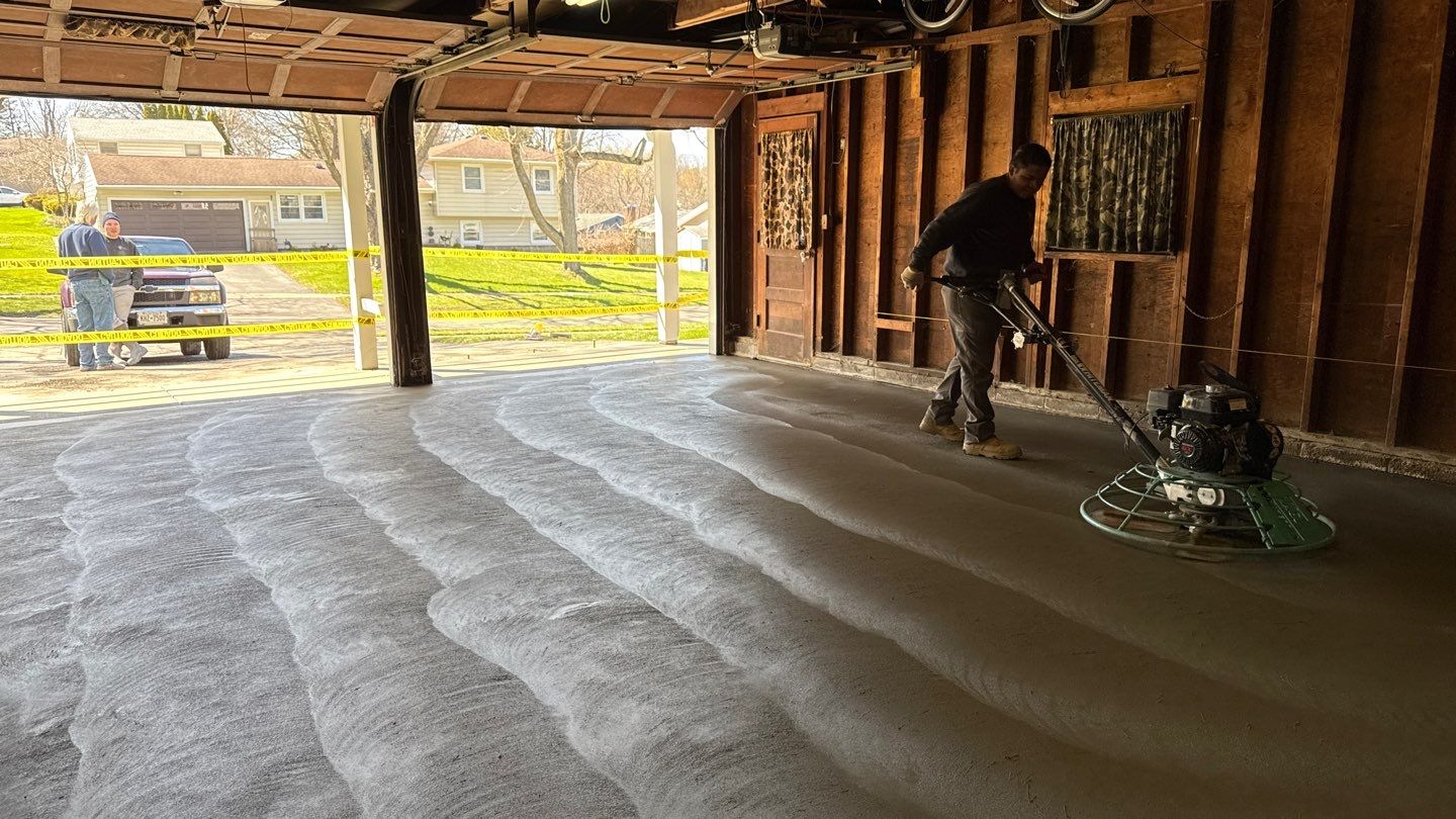 Concrete garage floor replacement with a broom finished apron and sidewalk by NG Masonry & Construction LLC