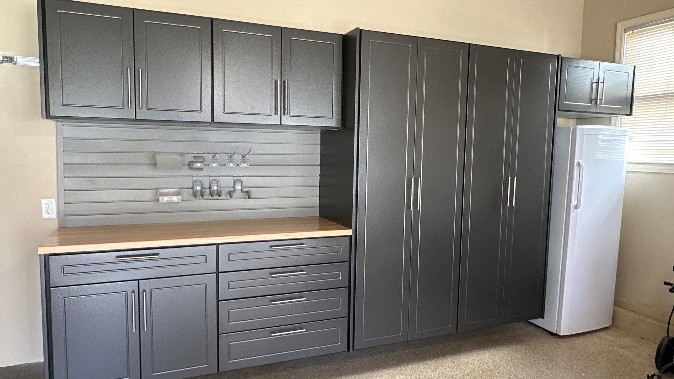 Trevor F. got a workbench with his garage cabinets.  by Banner Garage