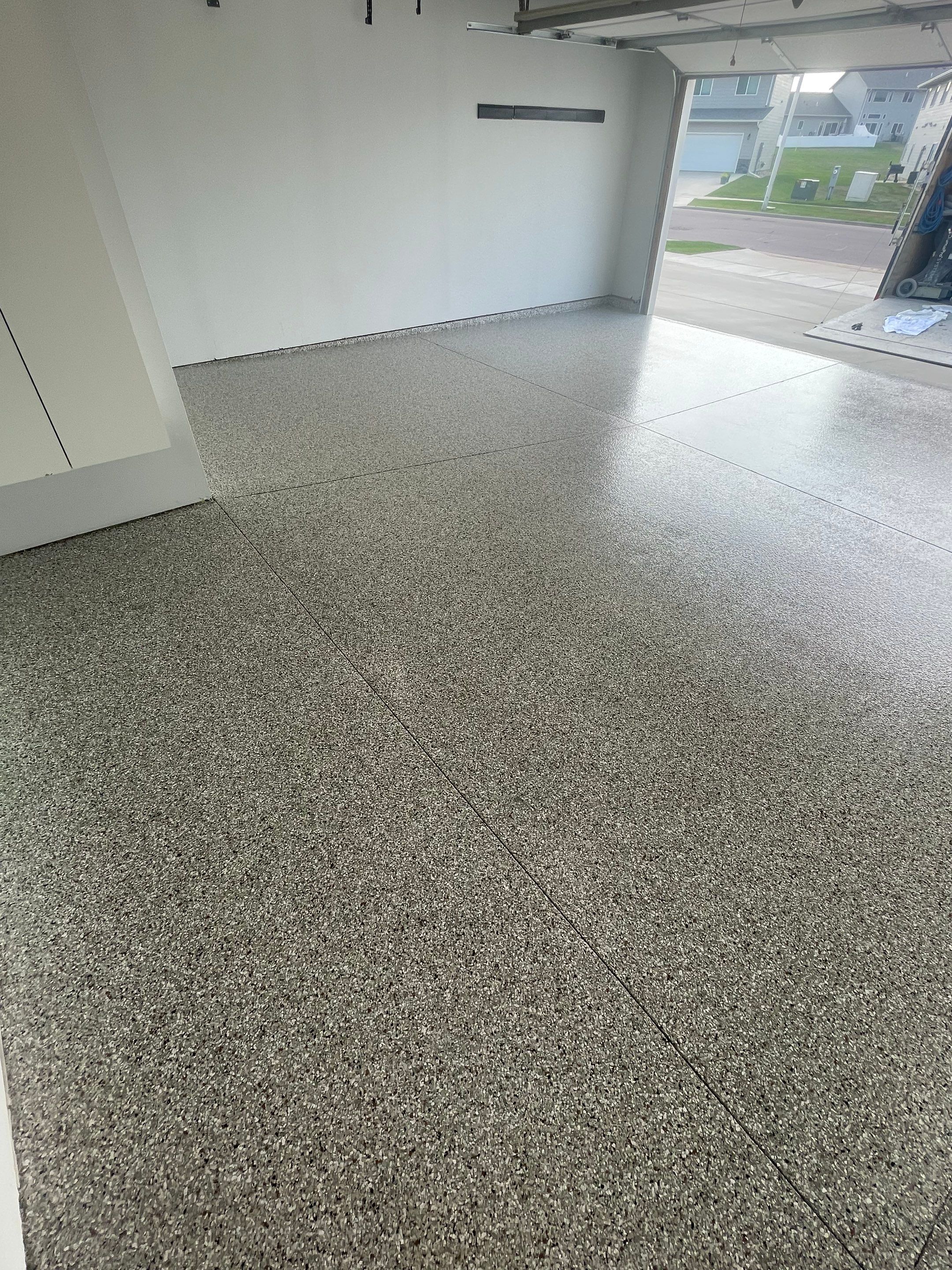 Custom Coyote Flake Garage Floor Coating in Sioux Falls by Select Painting, Coatings & Garage Cabinets