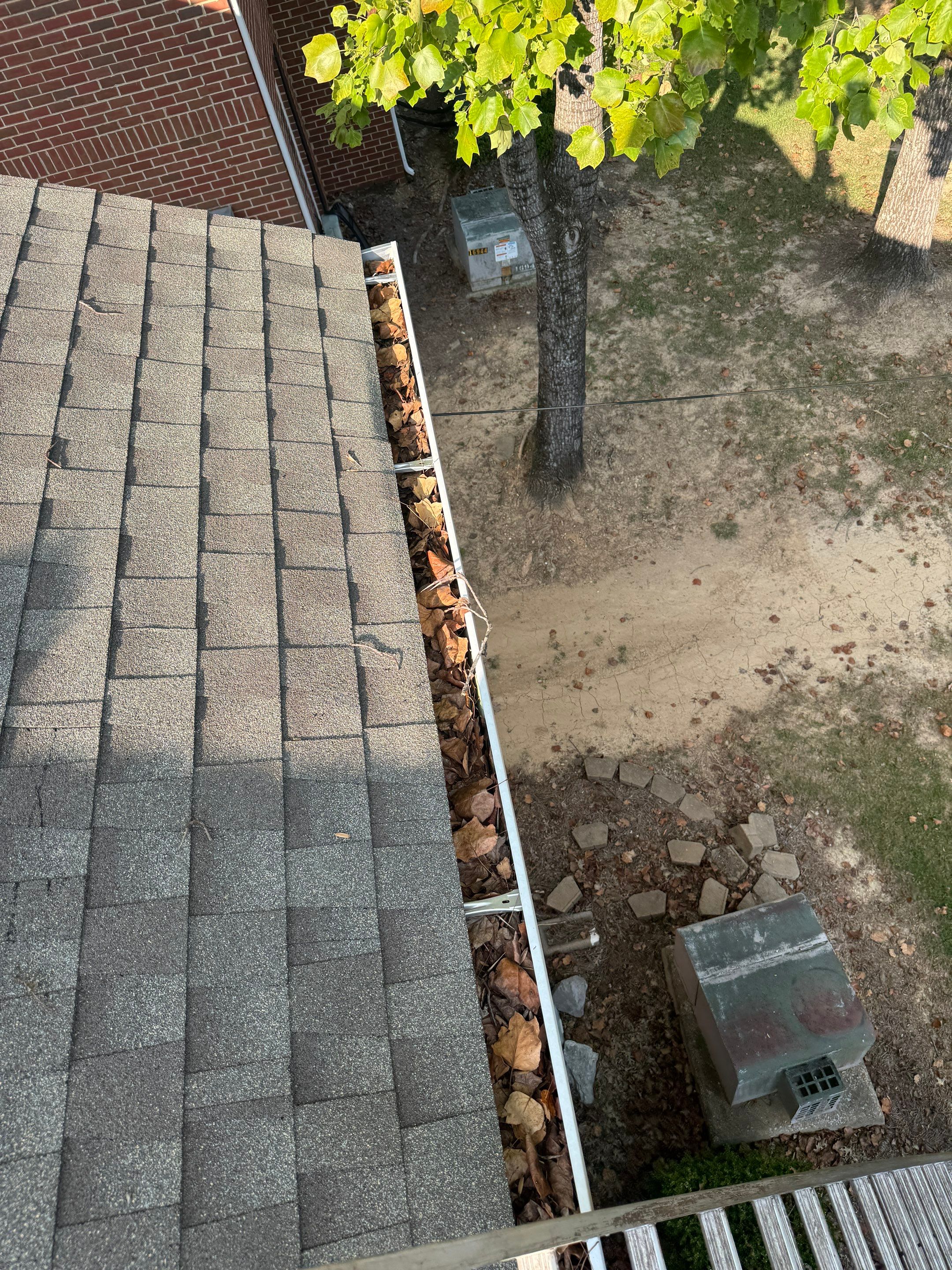 Commercial gutter cleaning Montgomery before photo with filled gutters