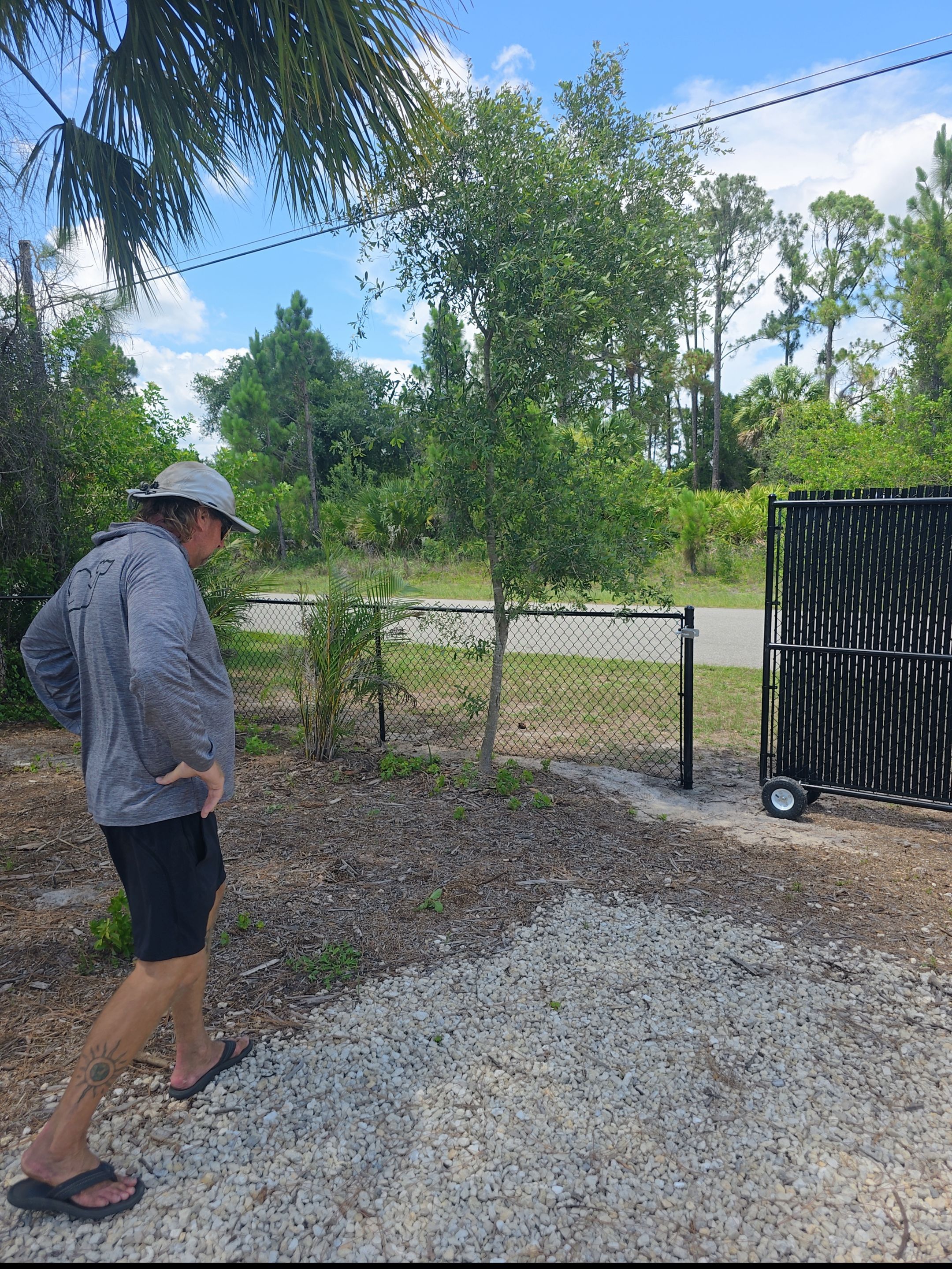 Black Vinyl-Coated Chain Link Fence and Rolling Gate Installation in North Port by True Fence LLC
