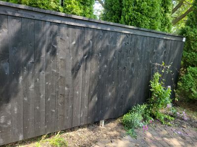 Black Wood Privacy Fence and Circular Stone Patio in Waverly