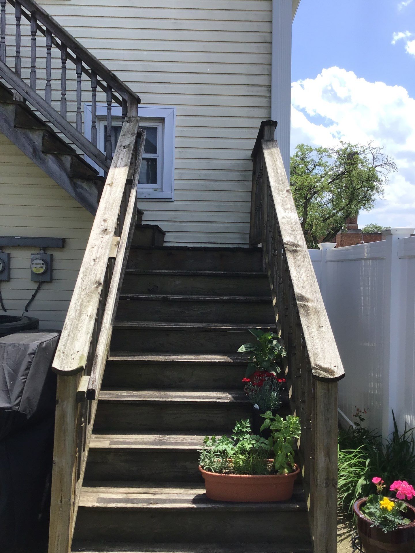 Rebuild balcony flat roofing TREX decking stairway and Railings in Wyandotte, MI by Northwest Construction 