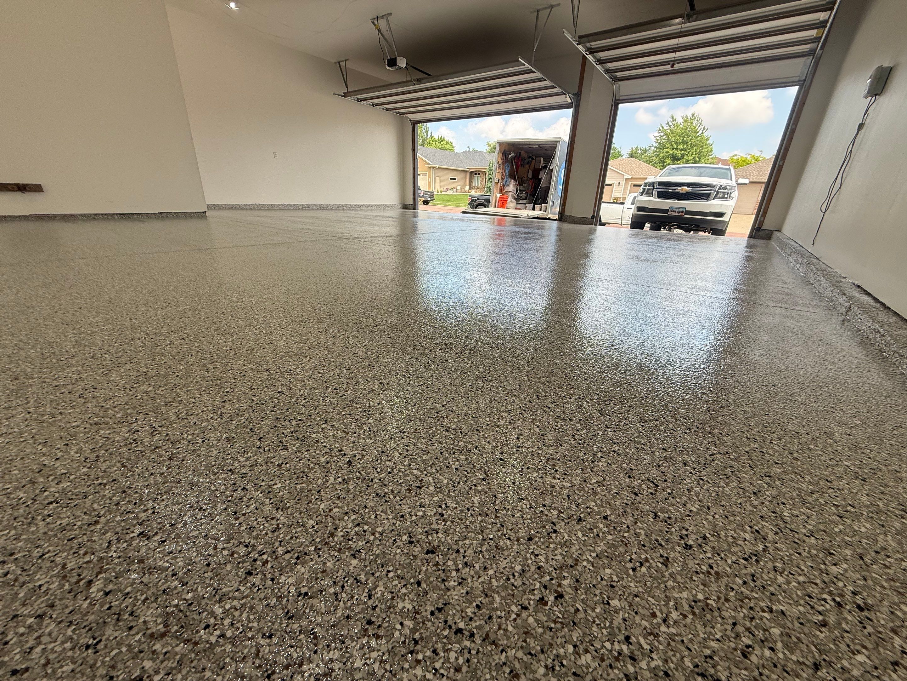 Full Garage Floor Resurfacing and Decorative Epoxy Flake Finish by Select Painting, Coatings & Garage Cabinets