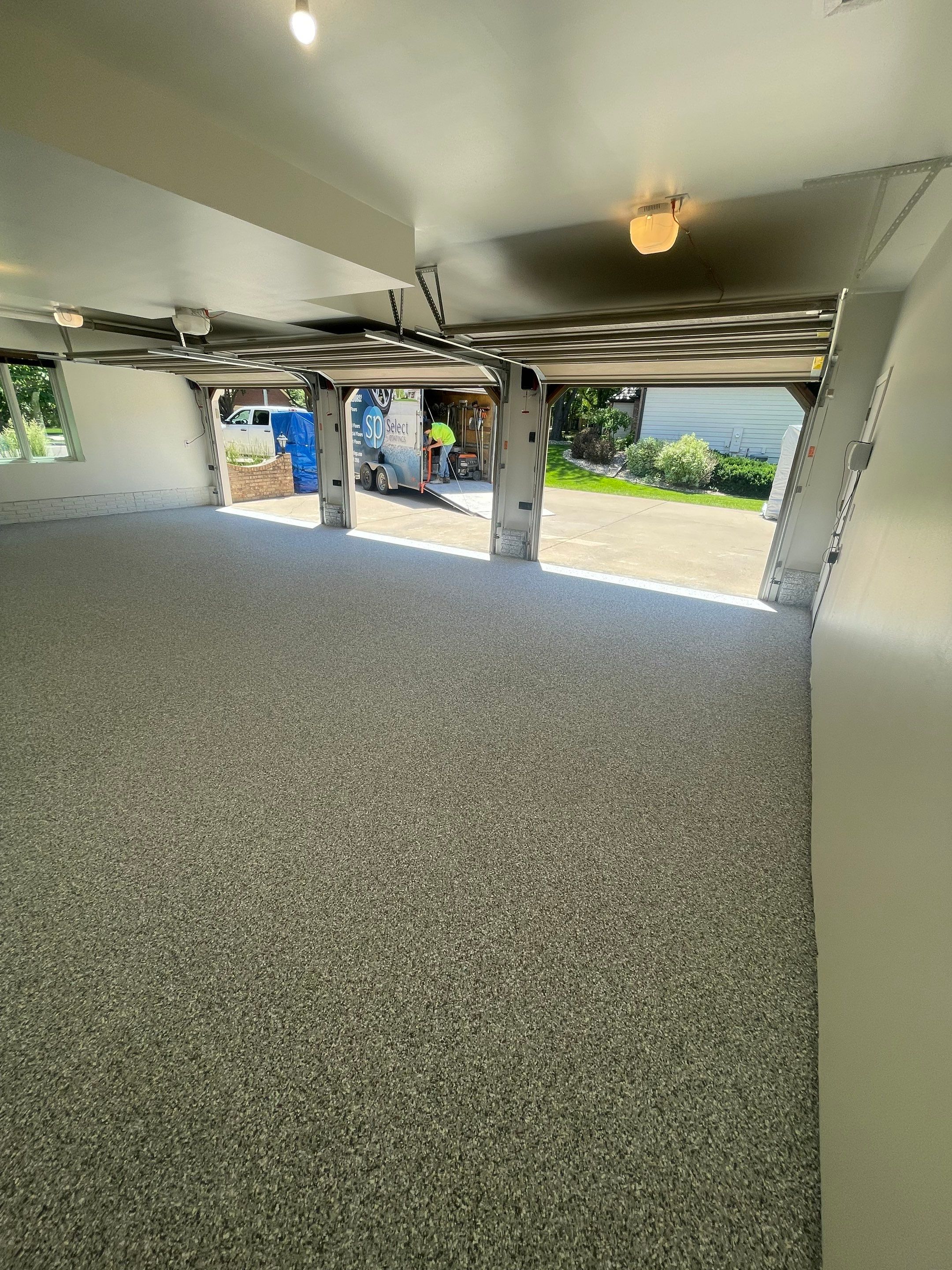 Gray Speckled Epoxy Garage Floor Coating in Sioux Falls by Select Painting, Coatings & Garage Cabinets