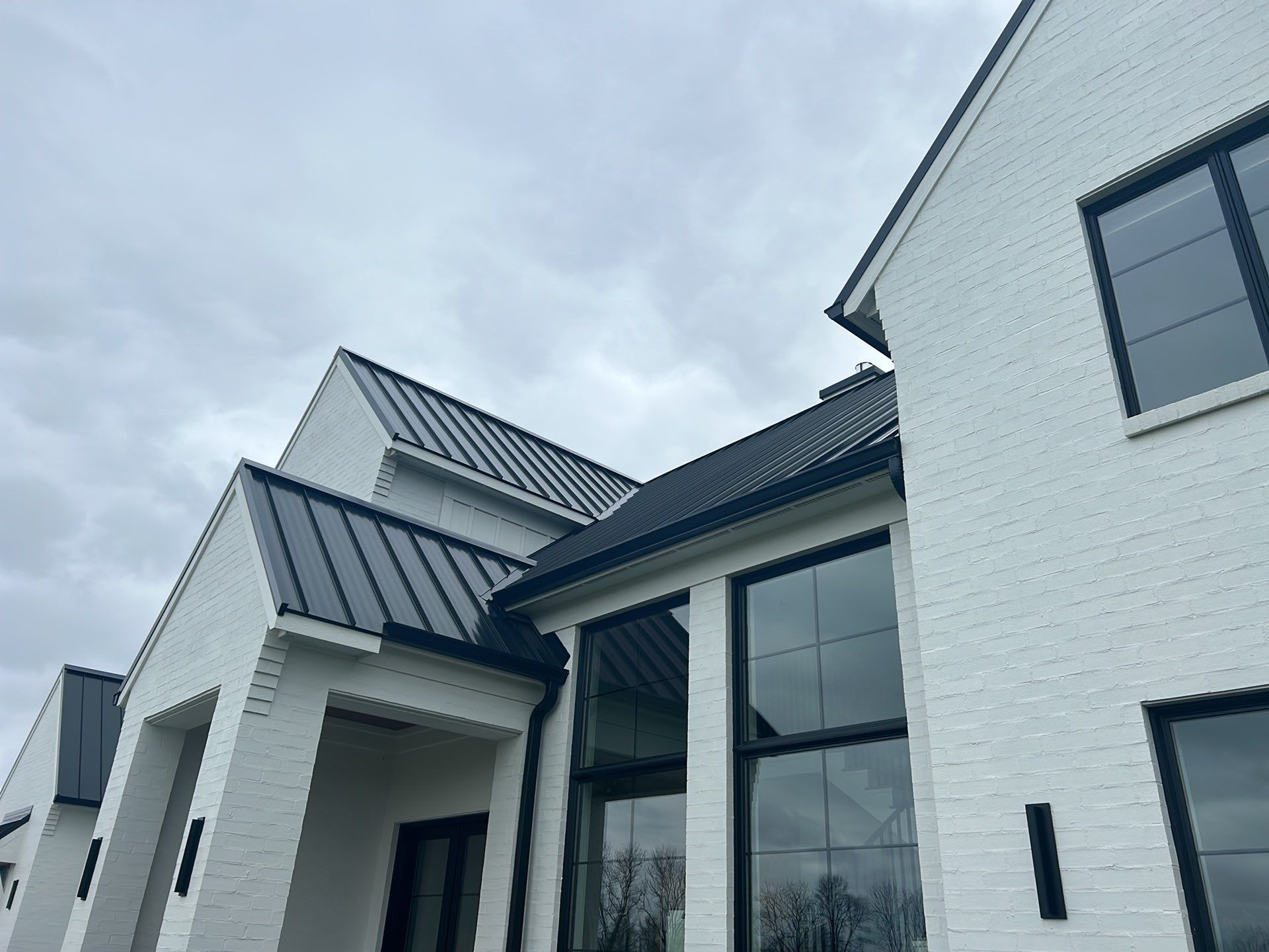 Residential Roofing Installation using Standing Seam Metal - Frost Black by RoofX 