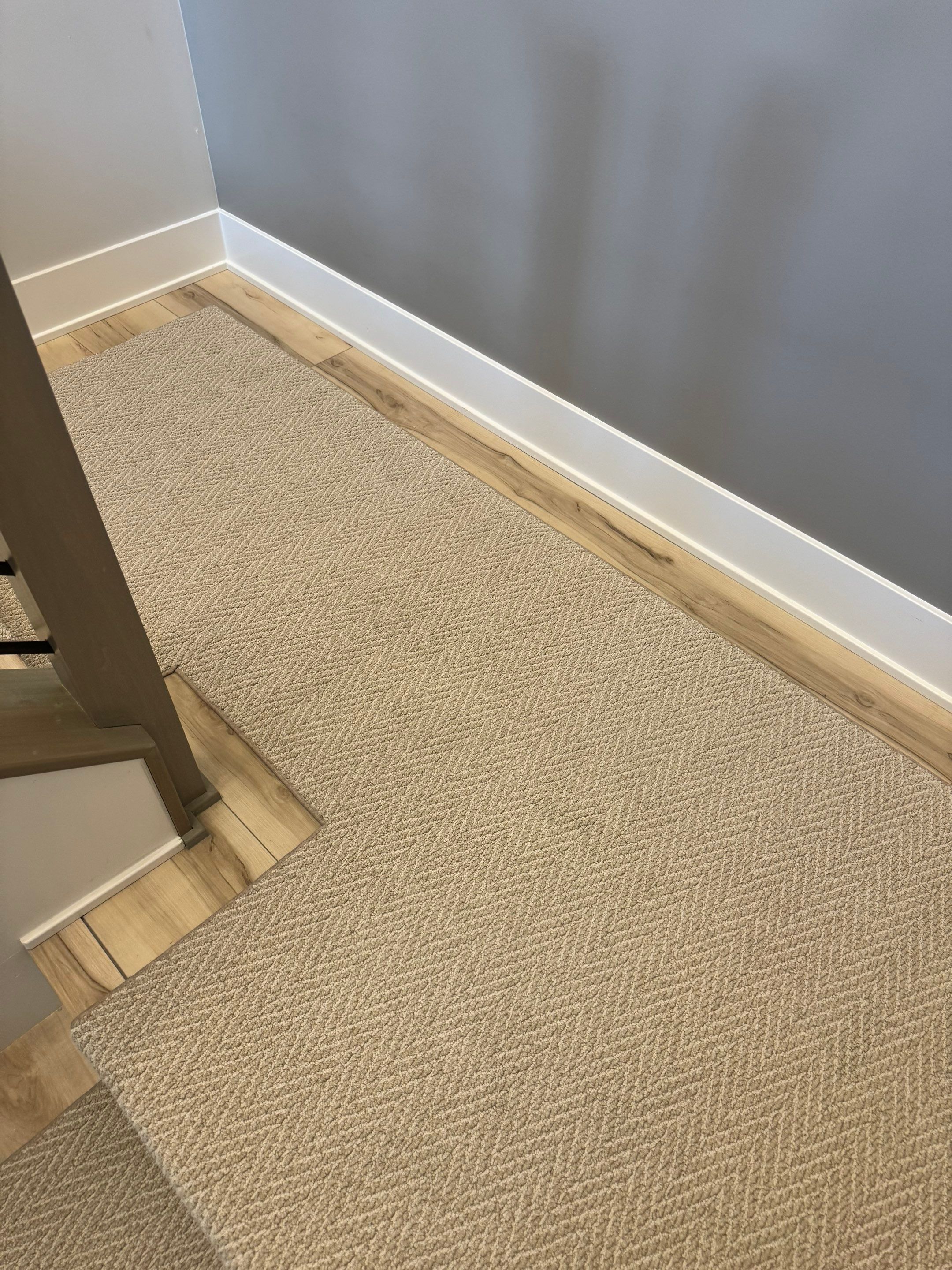 Fishers Staircase Renovation Featuring Custom Herringbone Runner and Modern Railing by Brothers Floor Covering INC.