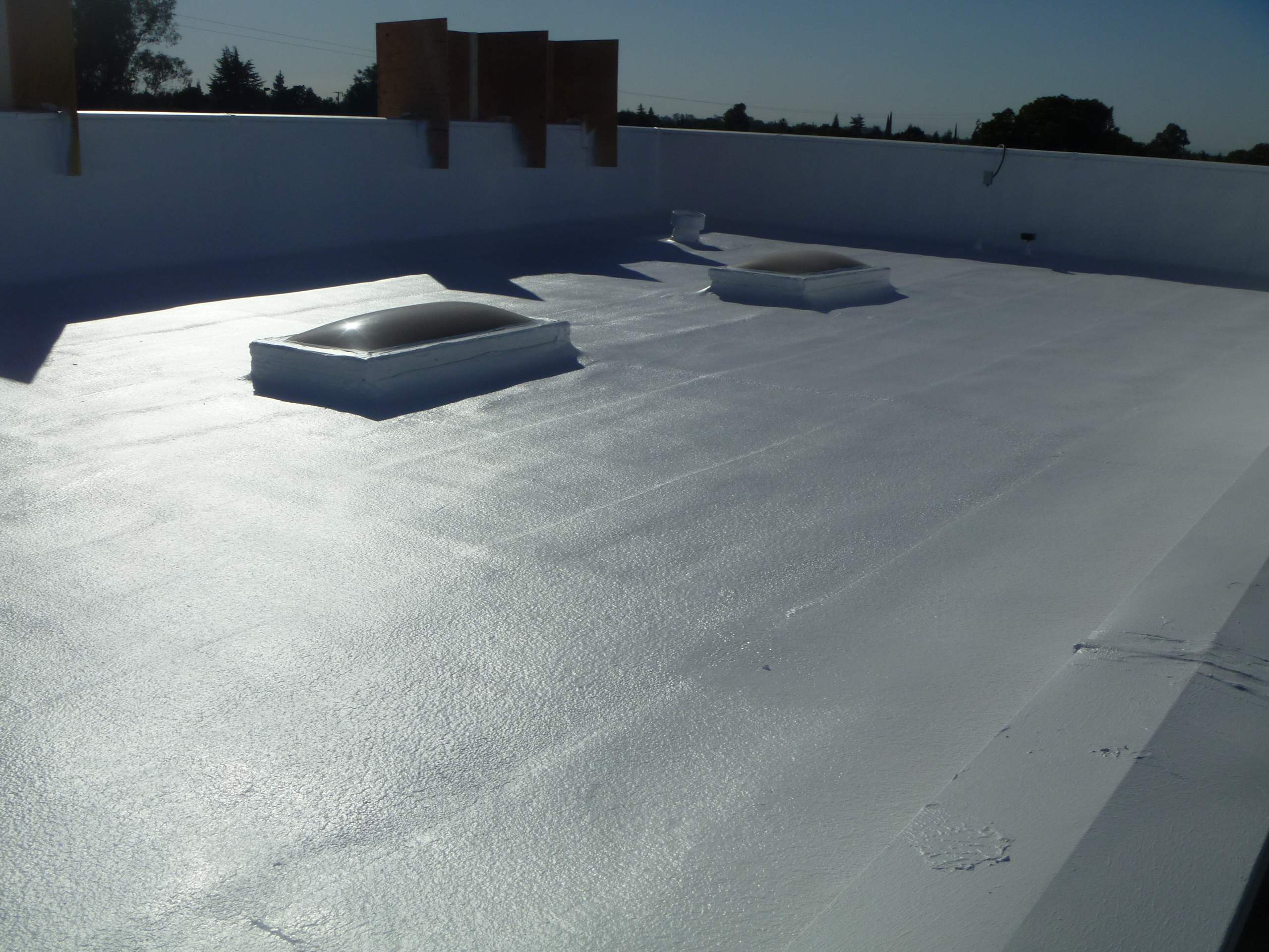 Commercial Roofing Installation using Spray foam and Conklin Benchmark/PUMA XL 18 yr warranty coatings by Straight Edge Roofing Inc