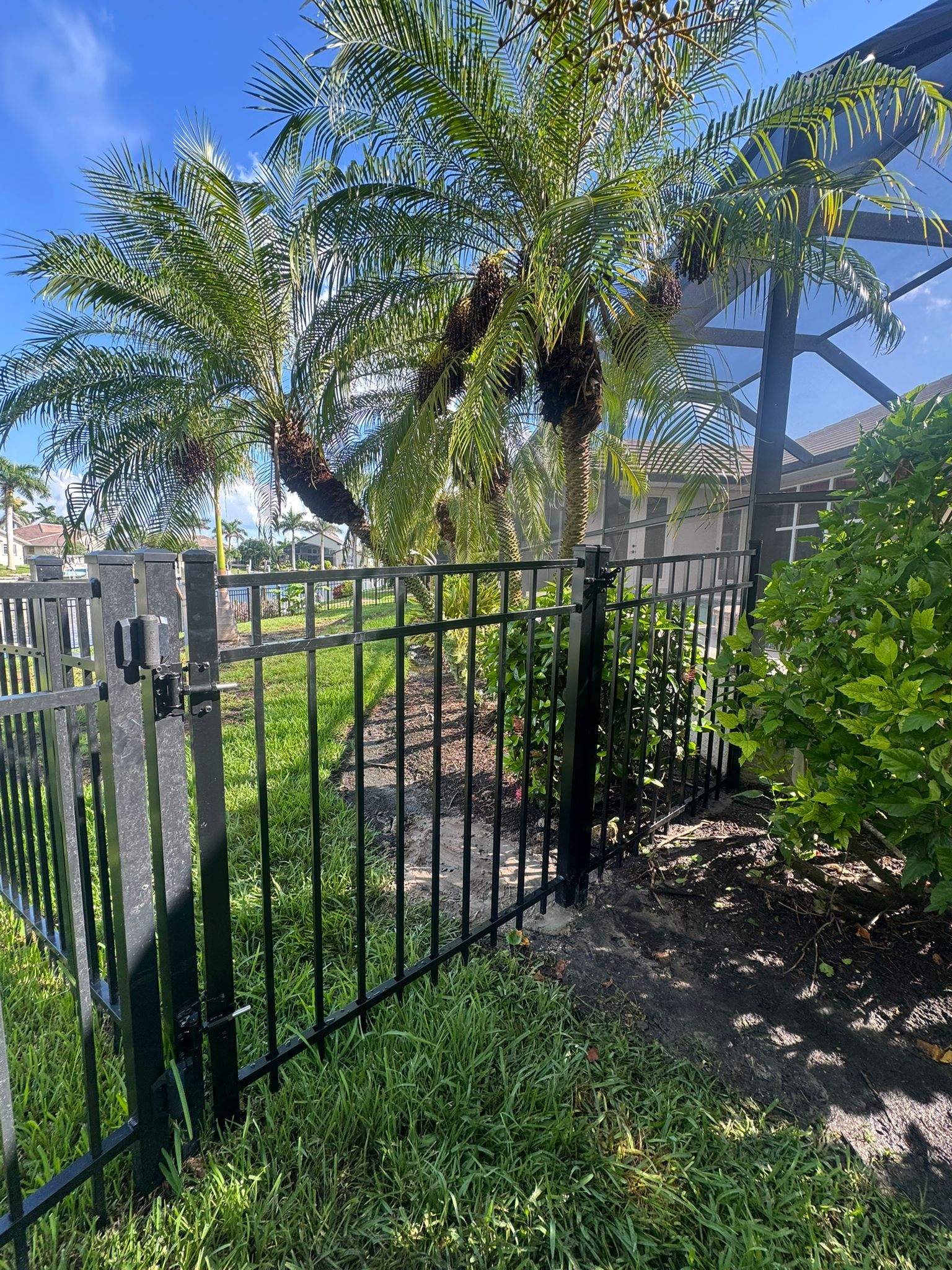 Black Aluminum Fence Installation Along Punta Gorda Canal by True Fence LLC
