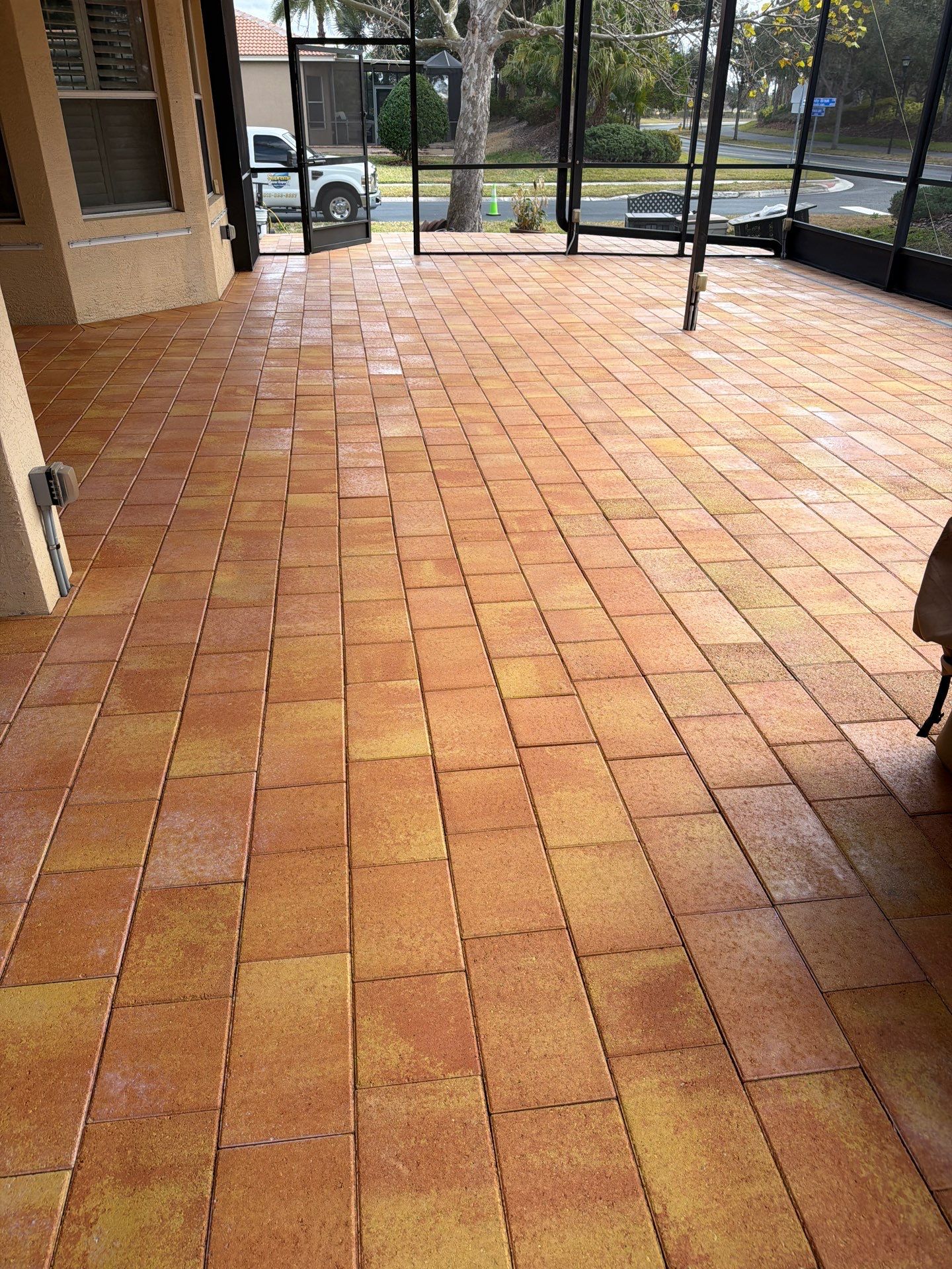 Paver Sealing for Herringbone Driveway and Screened Lanai in Valencia Lakes by Supreme Paver Experts