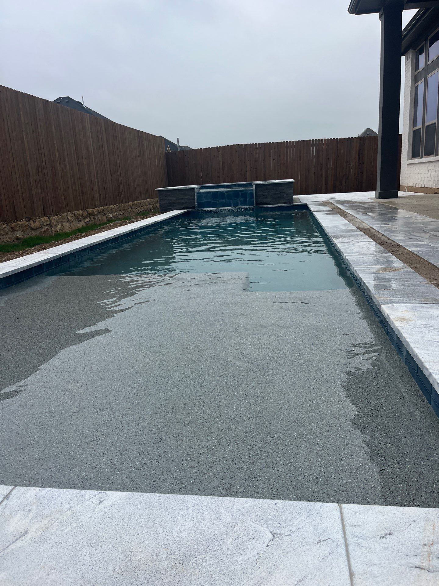 Geometric Pool with Raised Spa and Sheer Descent Waterfall by Pinnacle Pools and Spas - DFW