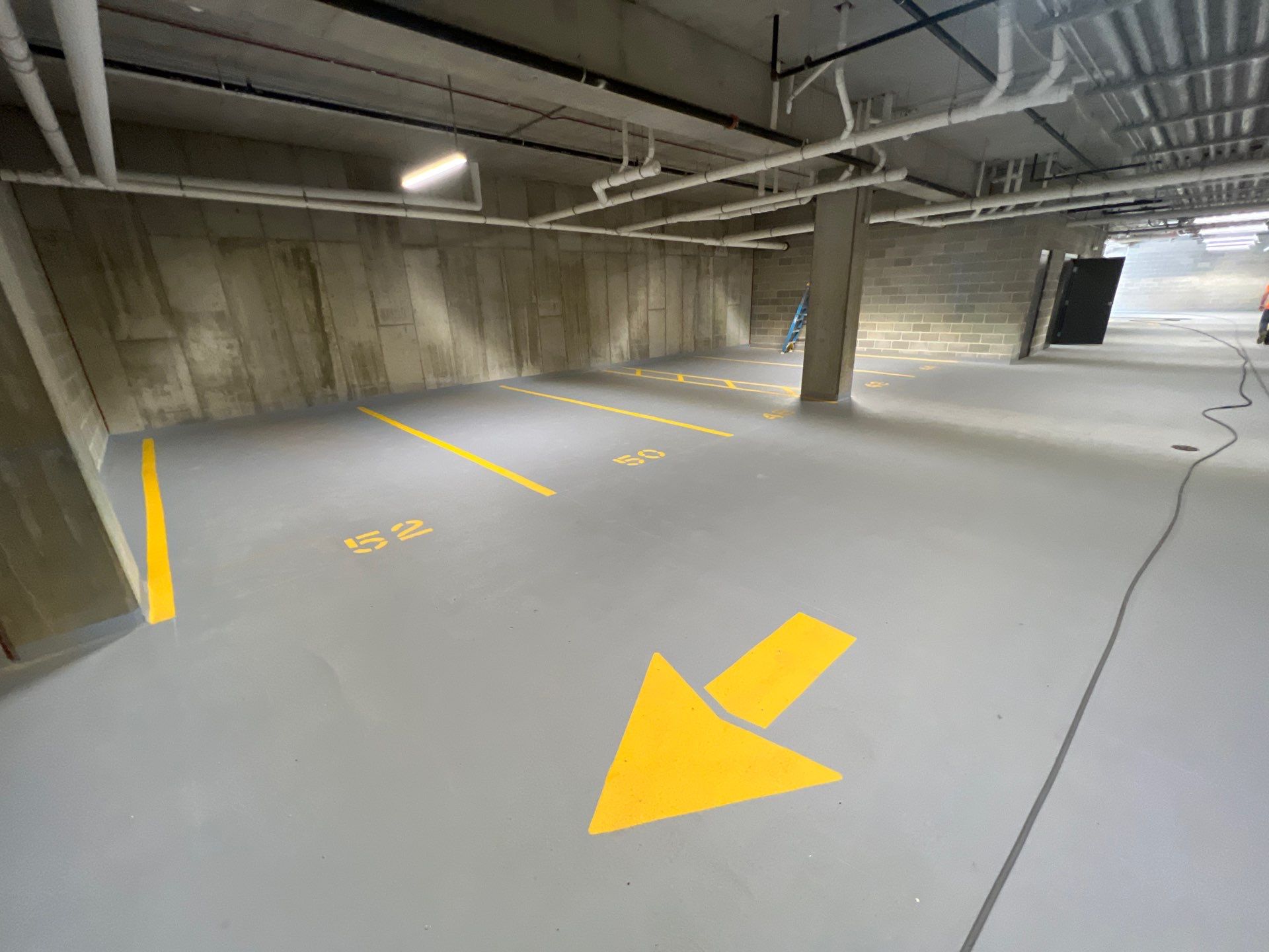 Parking garage using Hot water by Northern Power Washing LLC.