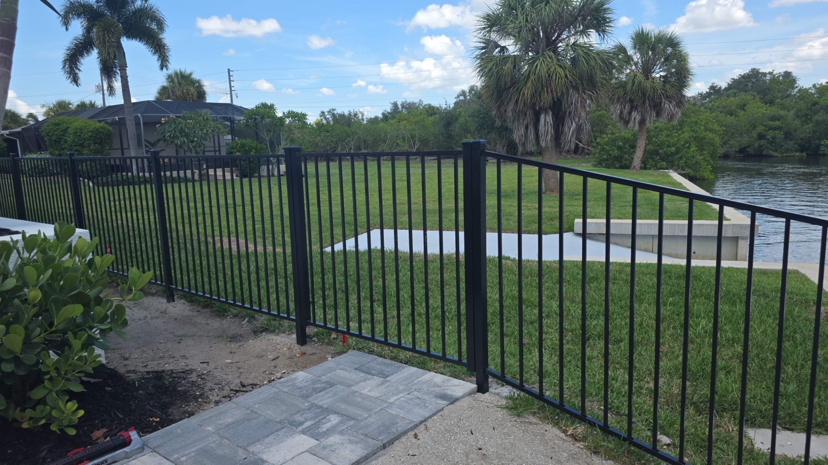 Black Aluminum Fencing and Paver Walkway Installation in Punta Gorda by True Fence LLC