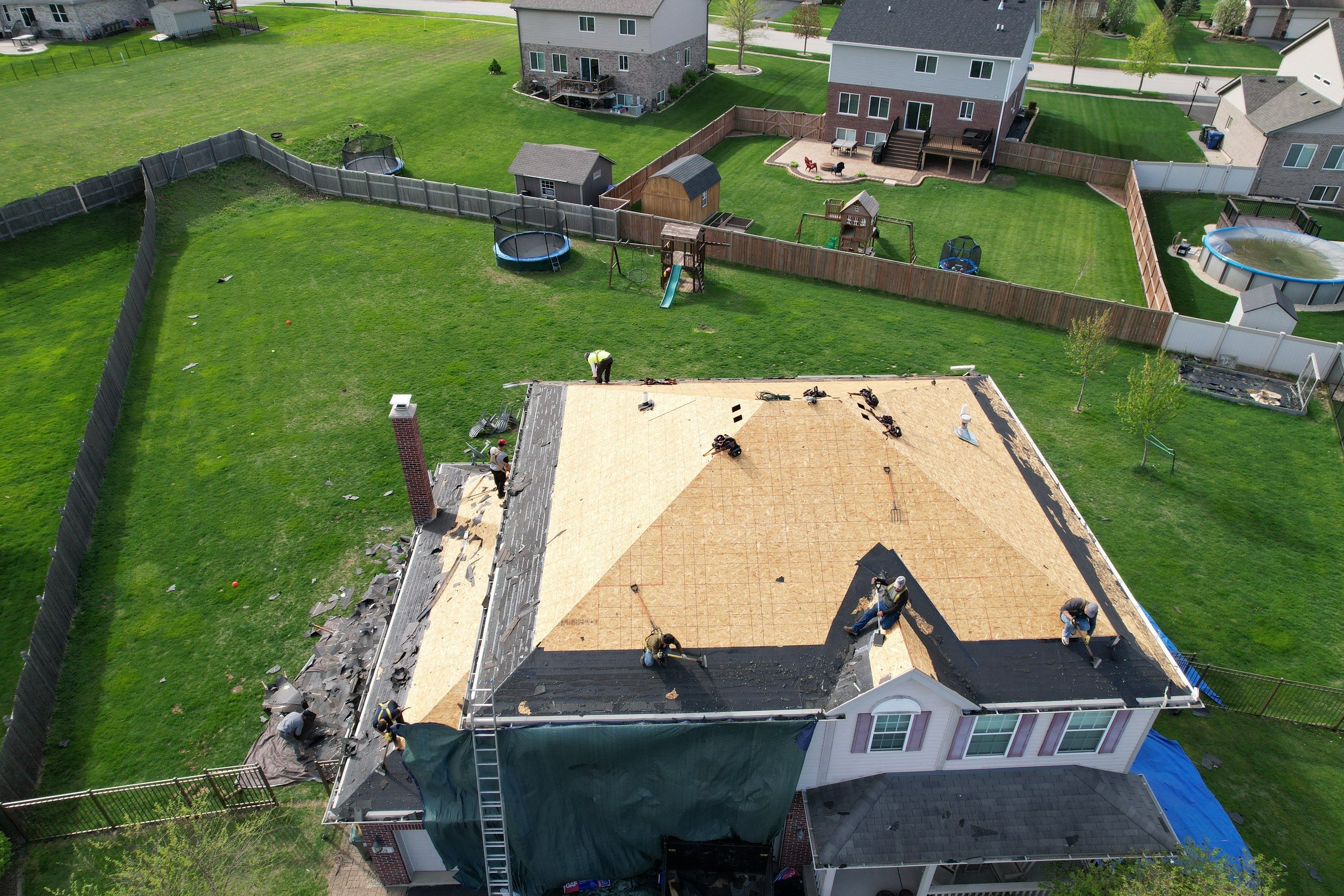 New black gutters and roof by Optimal Home Improvement 