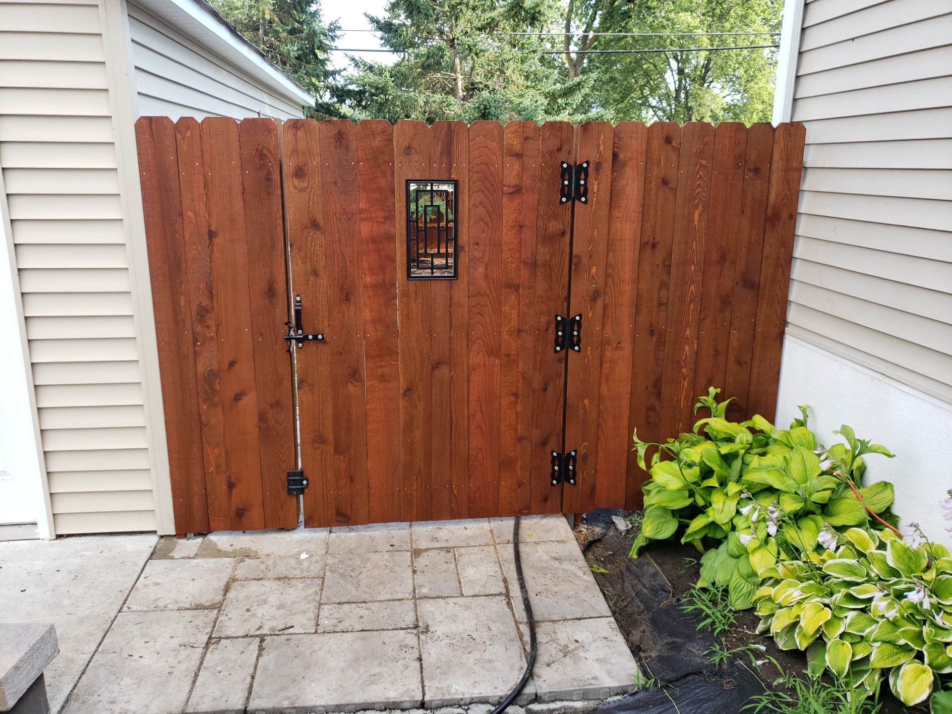 Custom Chestnut Stained Cedar Privacy Fence in Waterloo by Perfect Picket Fence and Stain