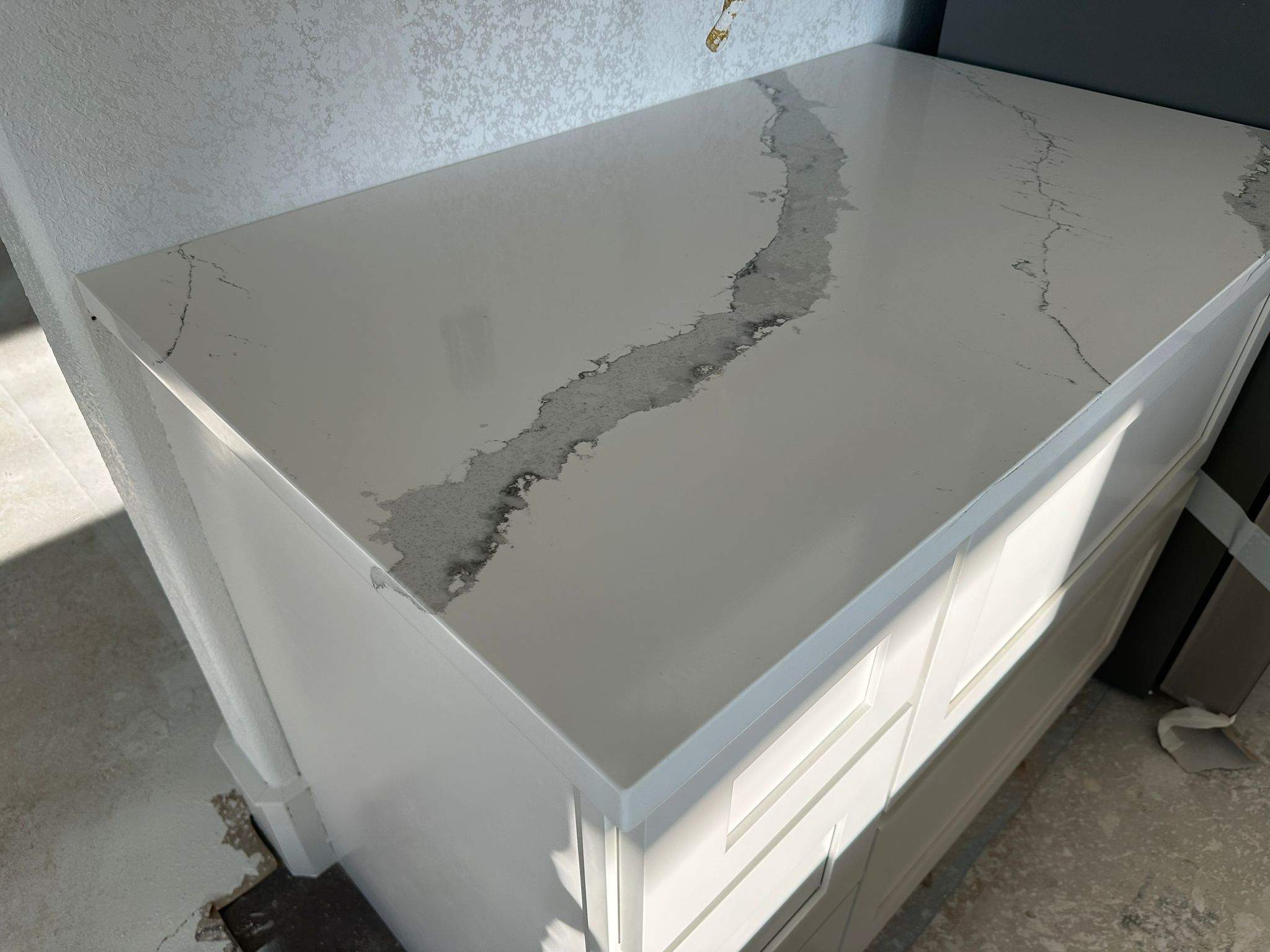 Kitchen and Bathroom Countertop Upgrades Featuring Gray Veined Quartz by Mena stone surfaces
