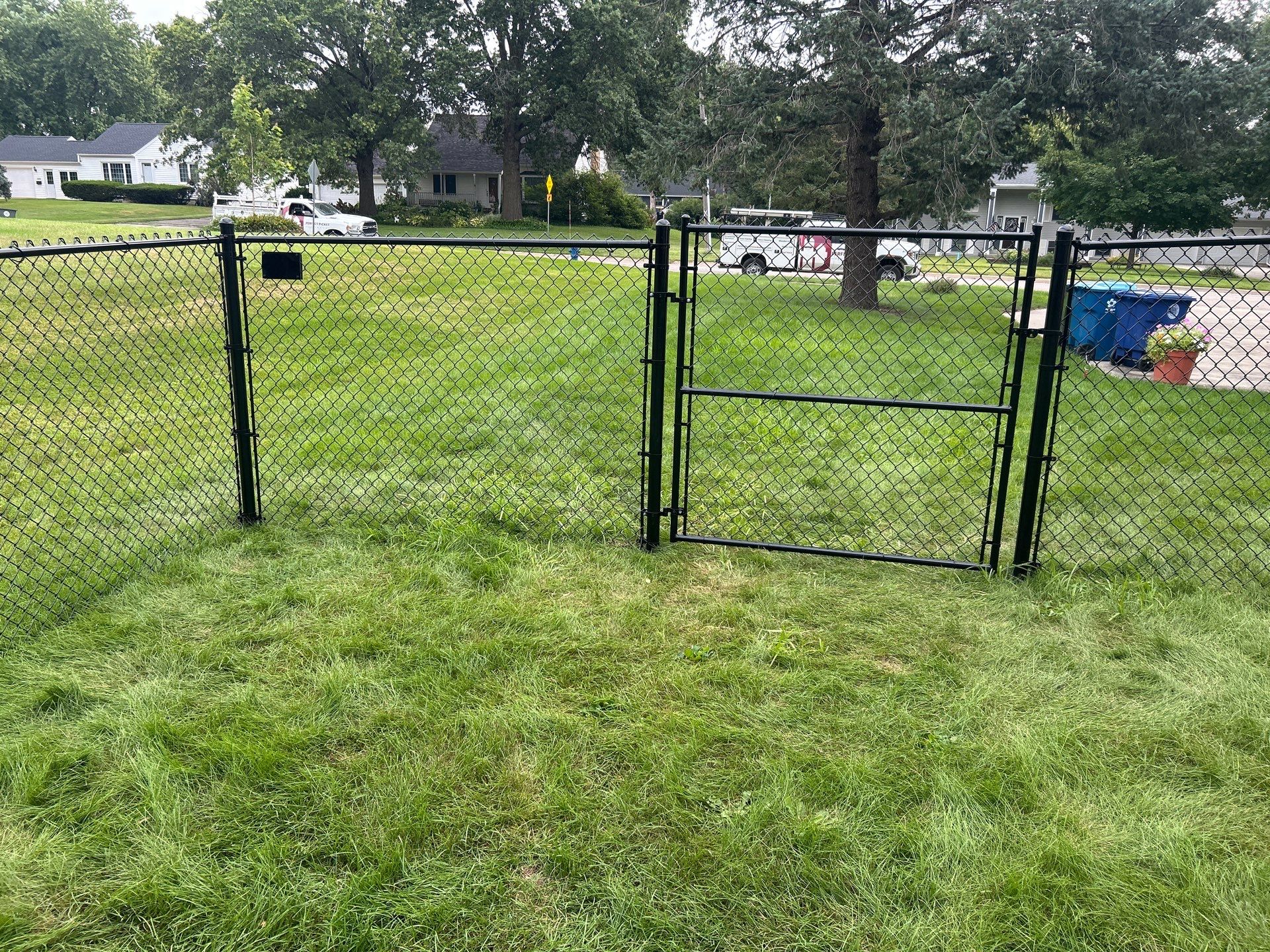 Black Vinyl Coated Chain Link Fence Installation in Waterloo by Perfect Picket Fence and Stain